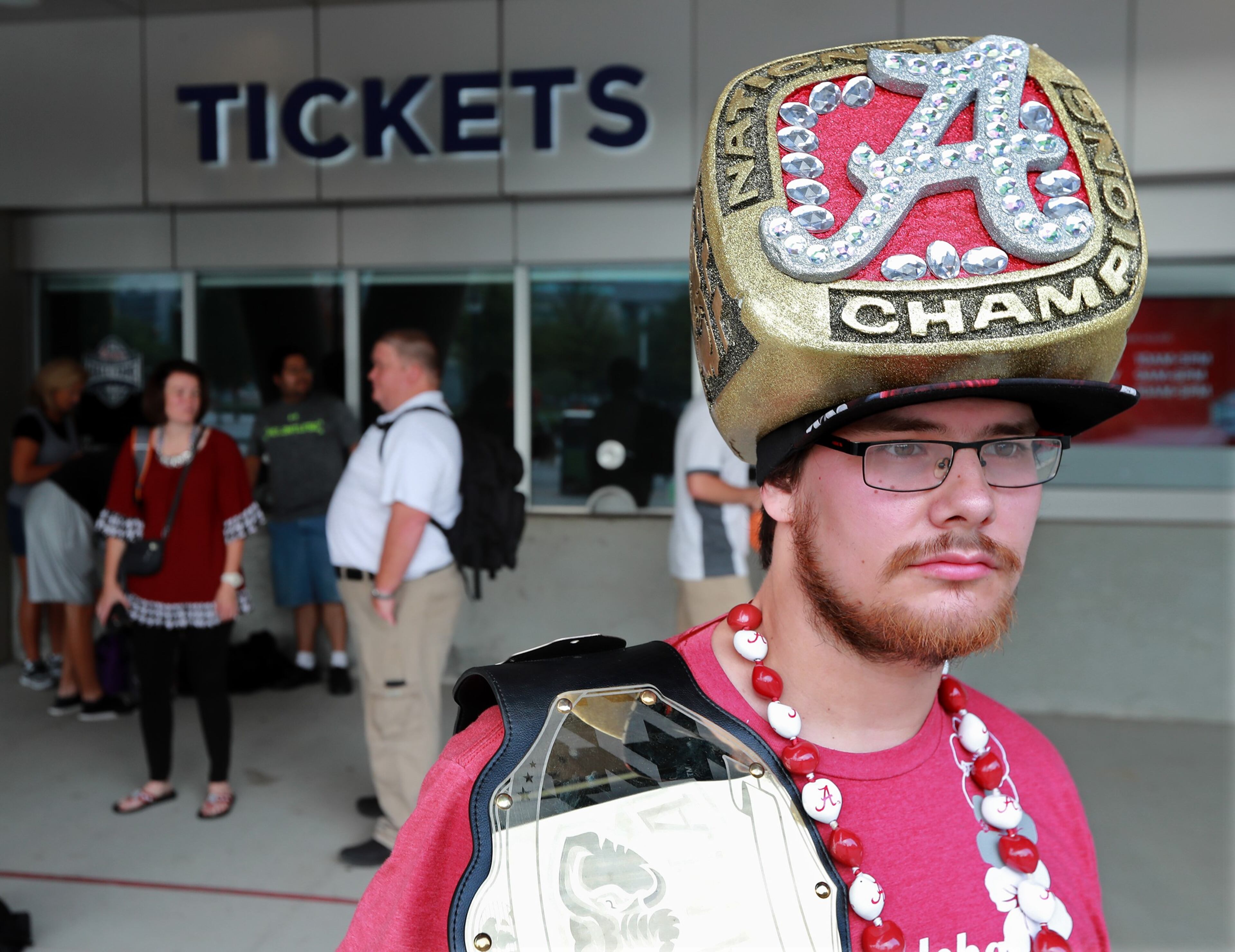 July 18, 2018 Atlanta: Alabama fan Shannon Villa, Birmingham, sports a national championship ring hat while waiting outside for the ticket window to open for SEC Media Days at the College Football Hall of Fame where head coach Nick Saban and select Alabama football athletes will hold press conferences along with Mississippi State, Tennessee, and Missouri on Wednesday, July 18, 2018, in Atlanta. Curtis Compton/ccompton@ajc.com