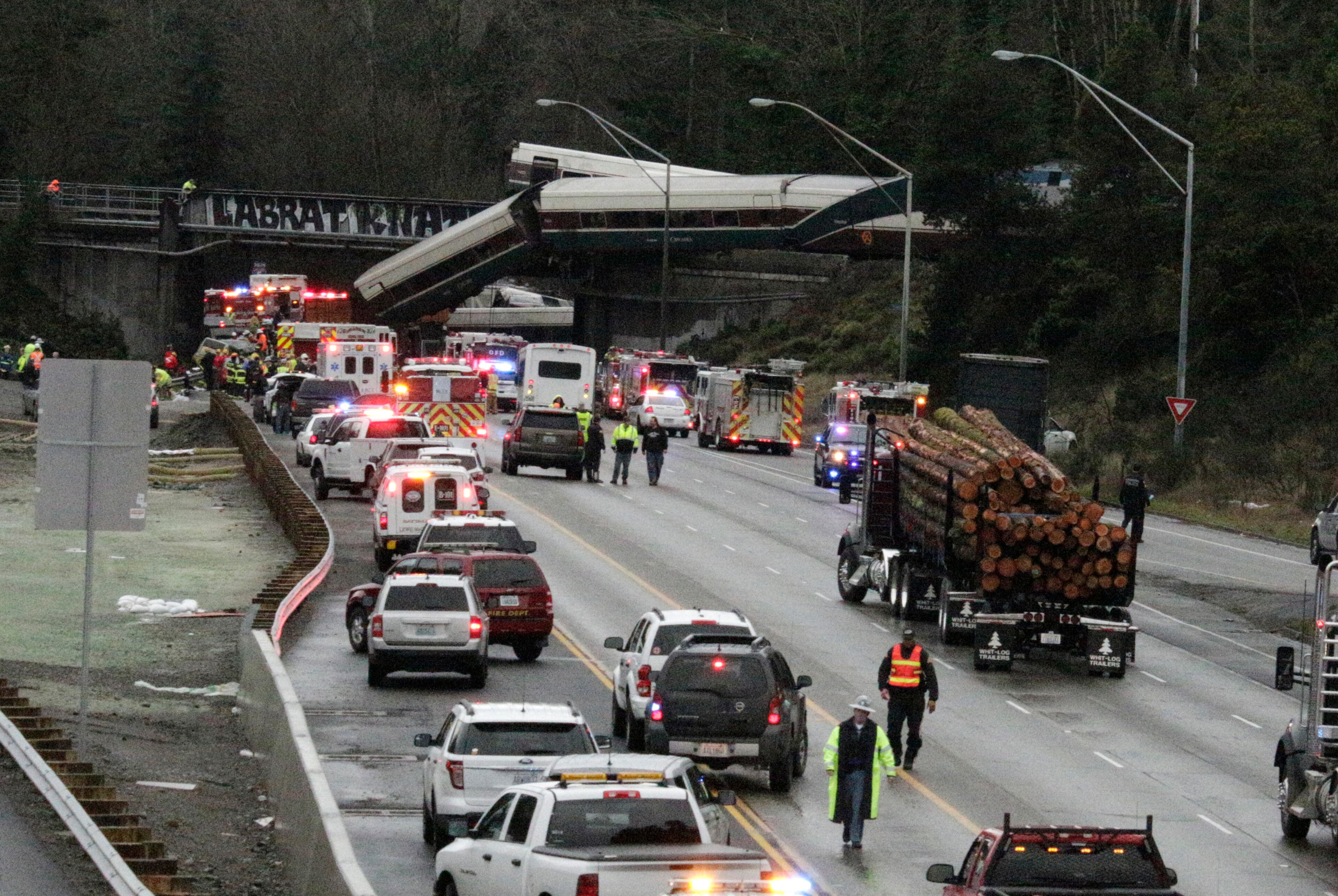 A derailed train is seen on southbound Interstate 5 on Monday, Dec. 18, 2017, in DuPont, Wash. An Amtrak train making an inaugural run on a new route derailed south of Seattle on Monday, spilling train cars onto a busy interstate in an accident that resulted in "multiple fatalities" and numerous injuries, authorities said. (AP Photo/Rachel La Corte)