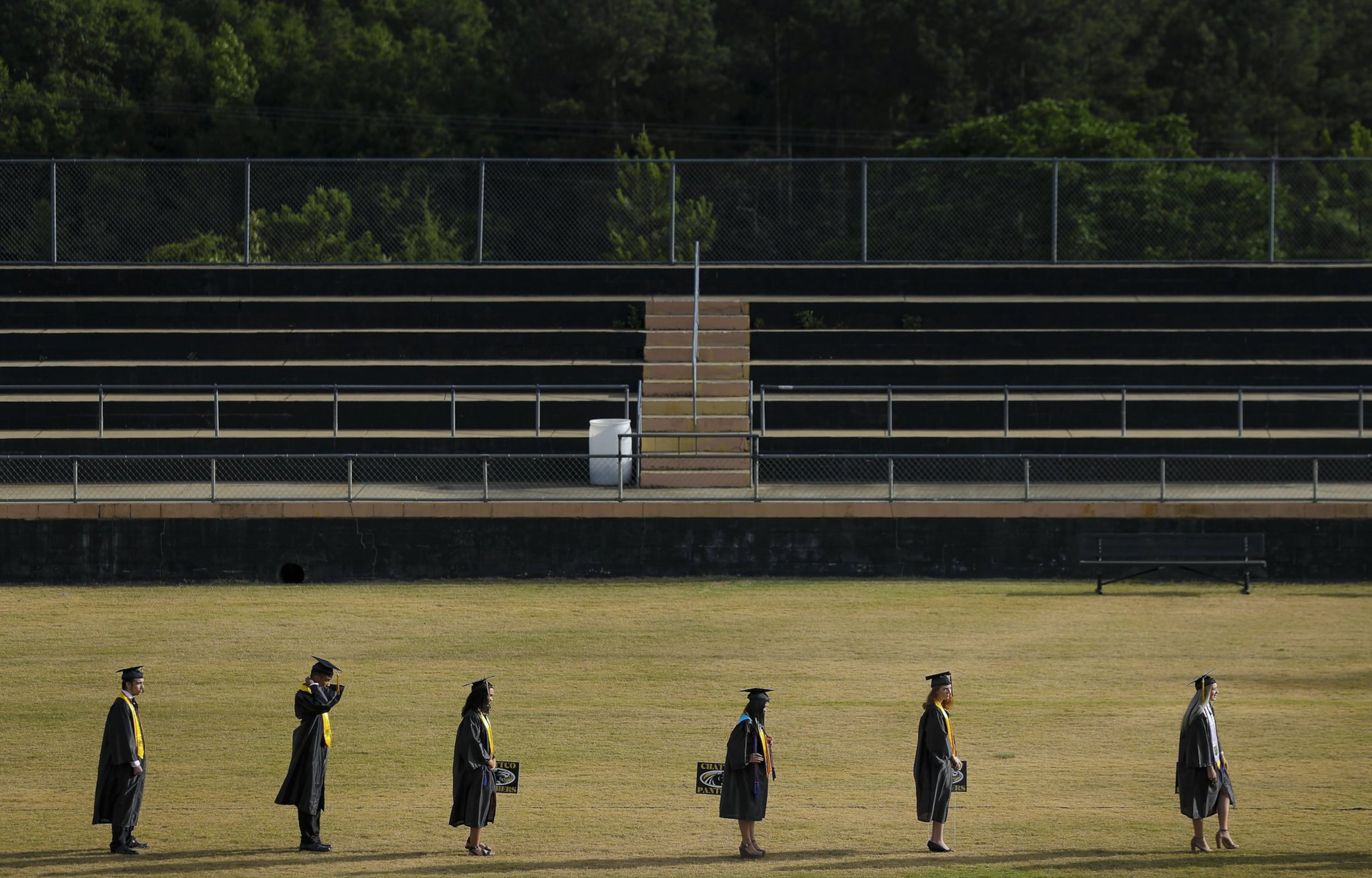 Graduating seniors in a line at Chattahoochee County High School on Friday, May 15, 2020, in Cusseta, Georgia. There were more than a hundred of them, and due to safety precautions they had to line up 10 at a time. With school restarting in August, educational leaders are considering their options, including a return to classrooms, full online instruction and a mix of online and in-person schooling.