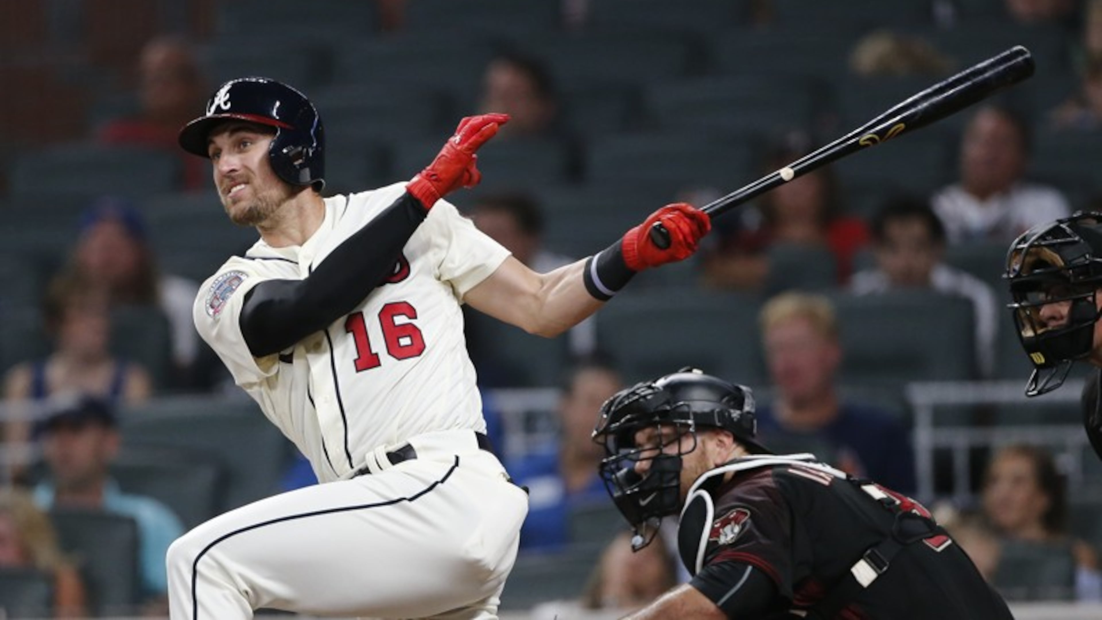 Lane Adams follows through on a three-run double against Arizona on July 15. (AP photo)