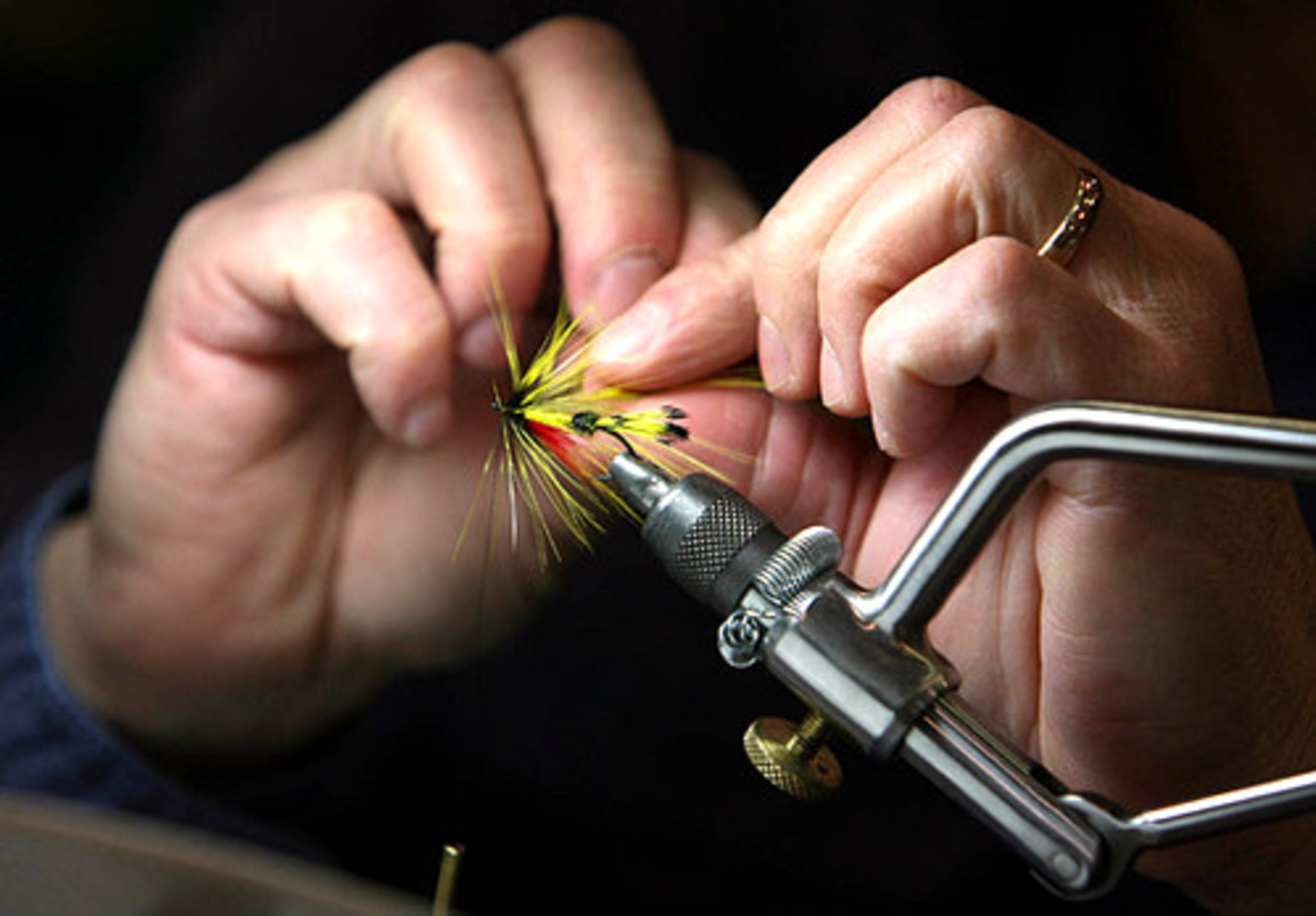 Max Birnkammer, of Smyrna, works on making a streamer fly.
