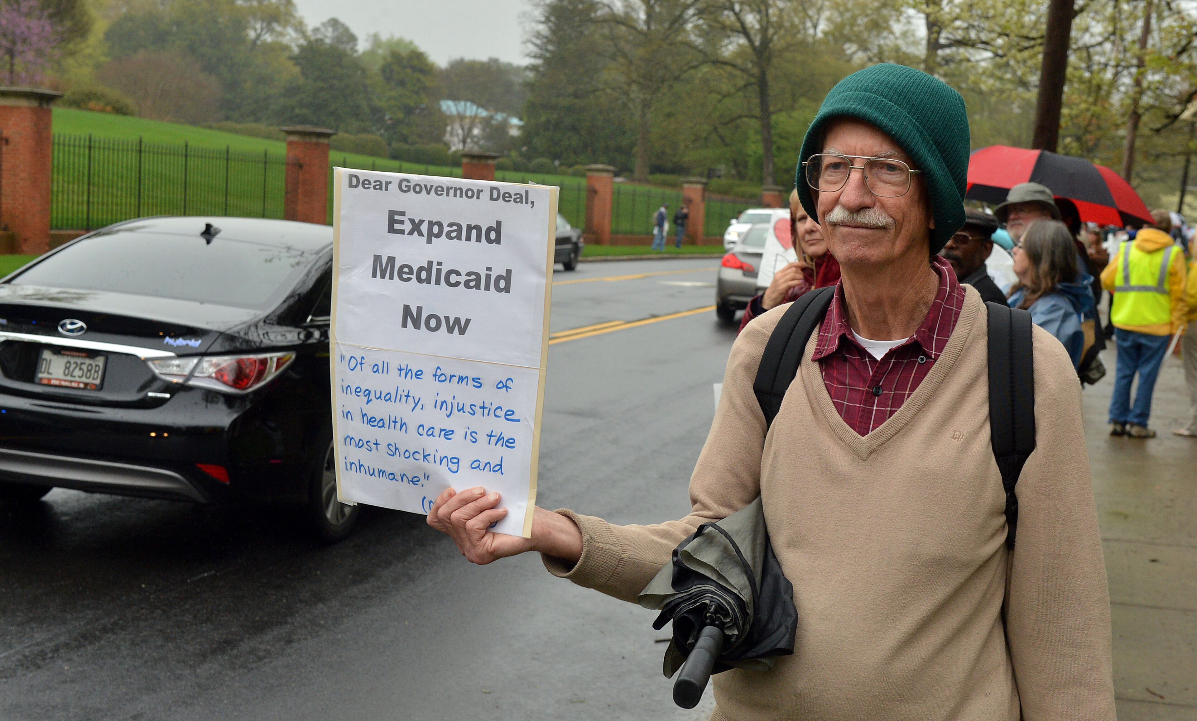 Bob Goodman of Decatur joins the protesters calling on Nathan Deal to expand Medicaid to more Georgians. The protest was outside the Governor's Mansion on W. Paces Ferry Road Monday, April 7, 2014. KENT D. JOHNSON / KDJOHNSON@AJC.COM