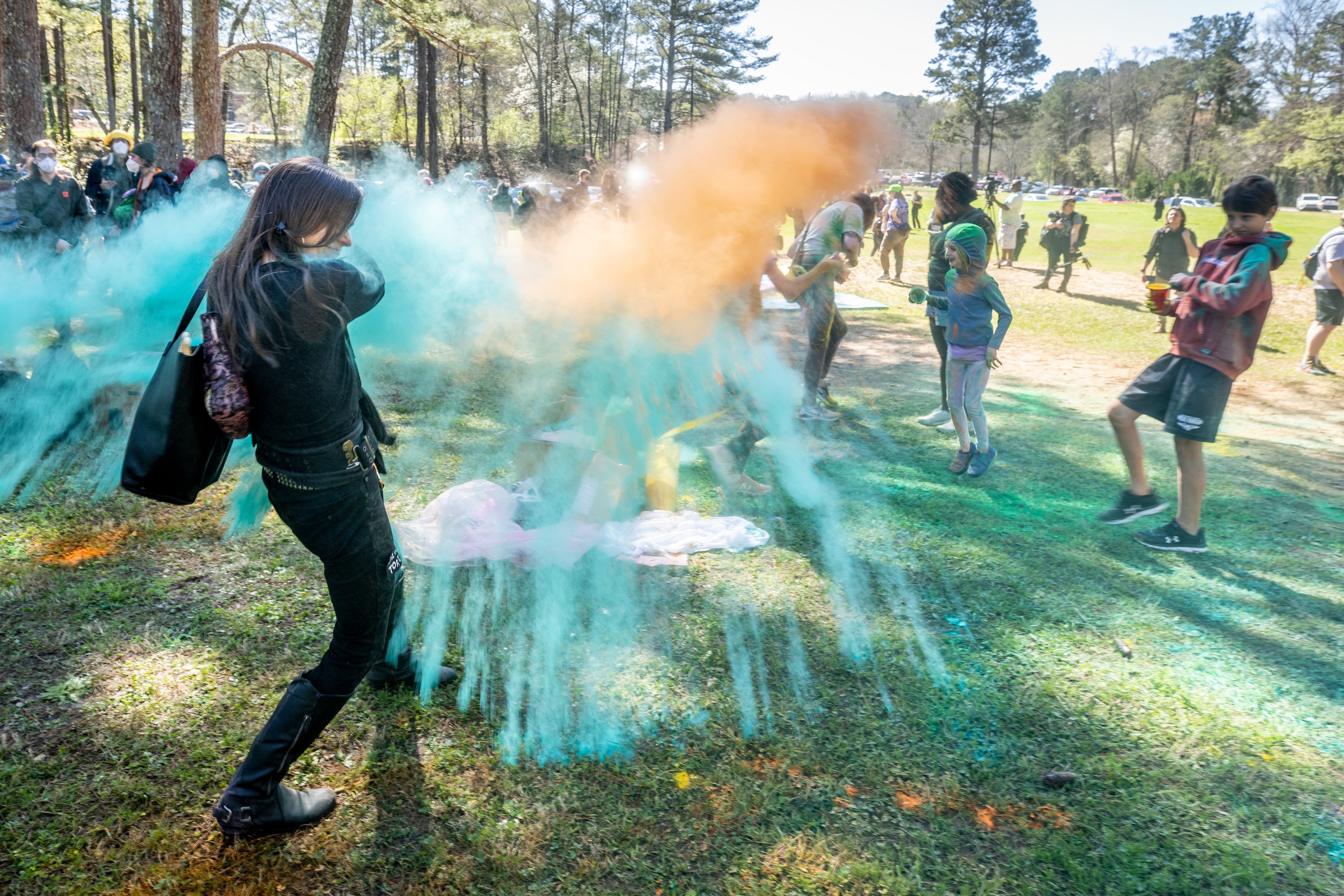People throw colored powder at the beginning of the Defend the Atlanta Forest and public safety training center protest at Gresham Park in Atlanta on Saturday, March 4, 2023. (Steve Schaefer/steve.schaefer@ajc.com)