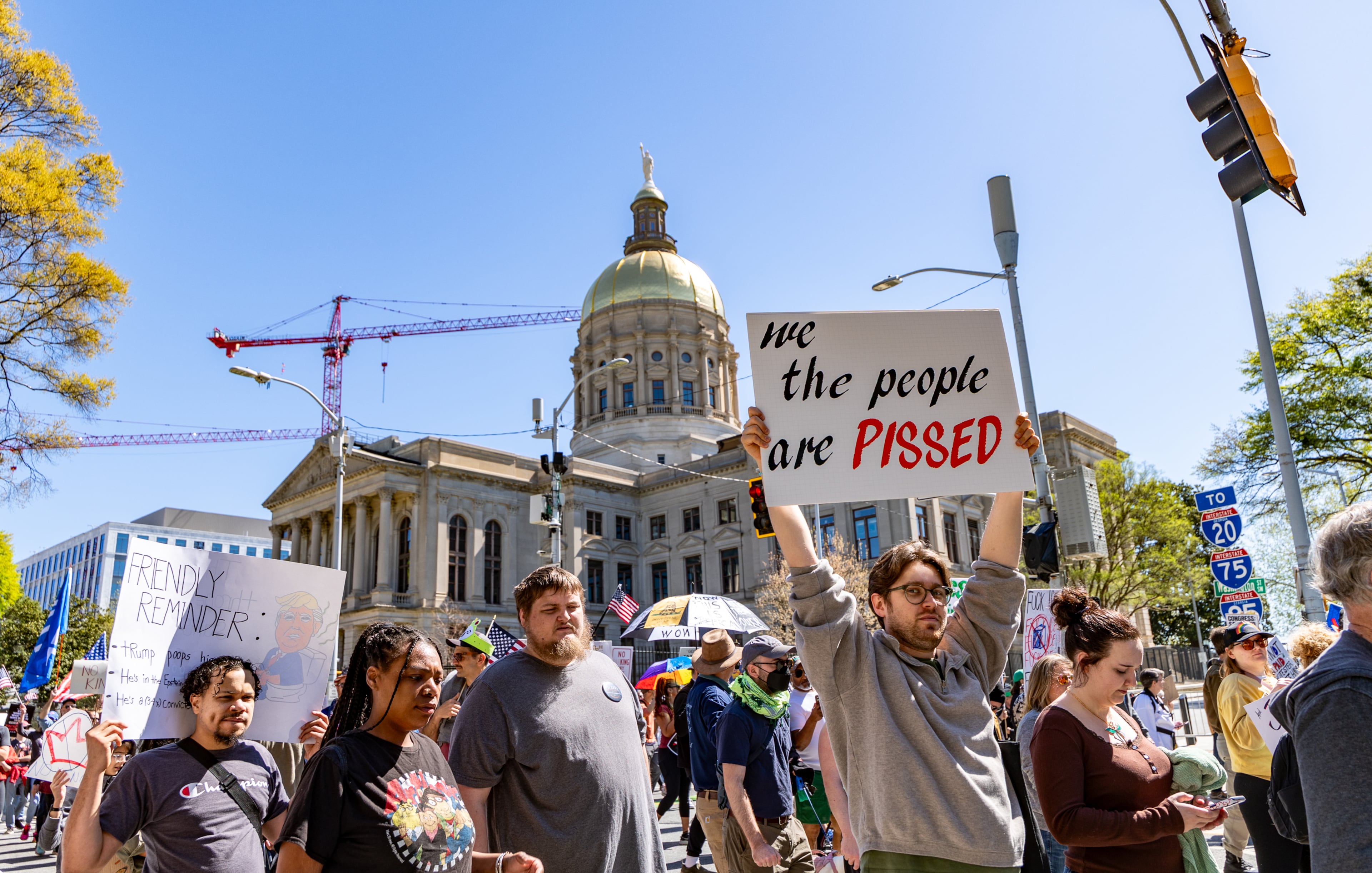 Demonstrators march around the state Capitol during the No Kings protest on Saturday, March 28, 2026, in Atlanta. (Jenni Girtman for the AJC)