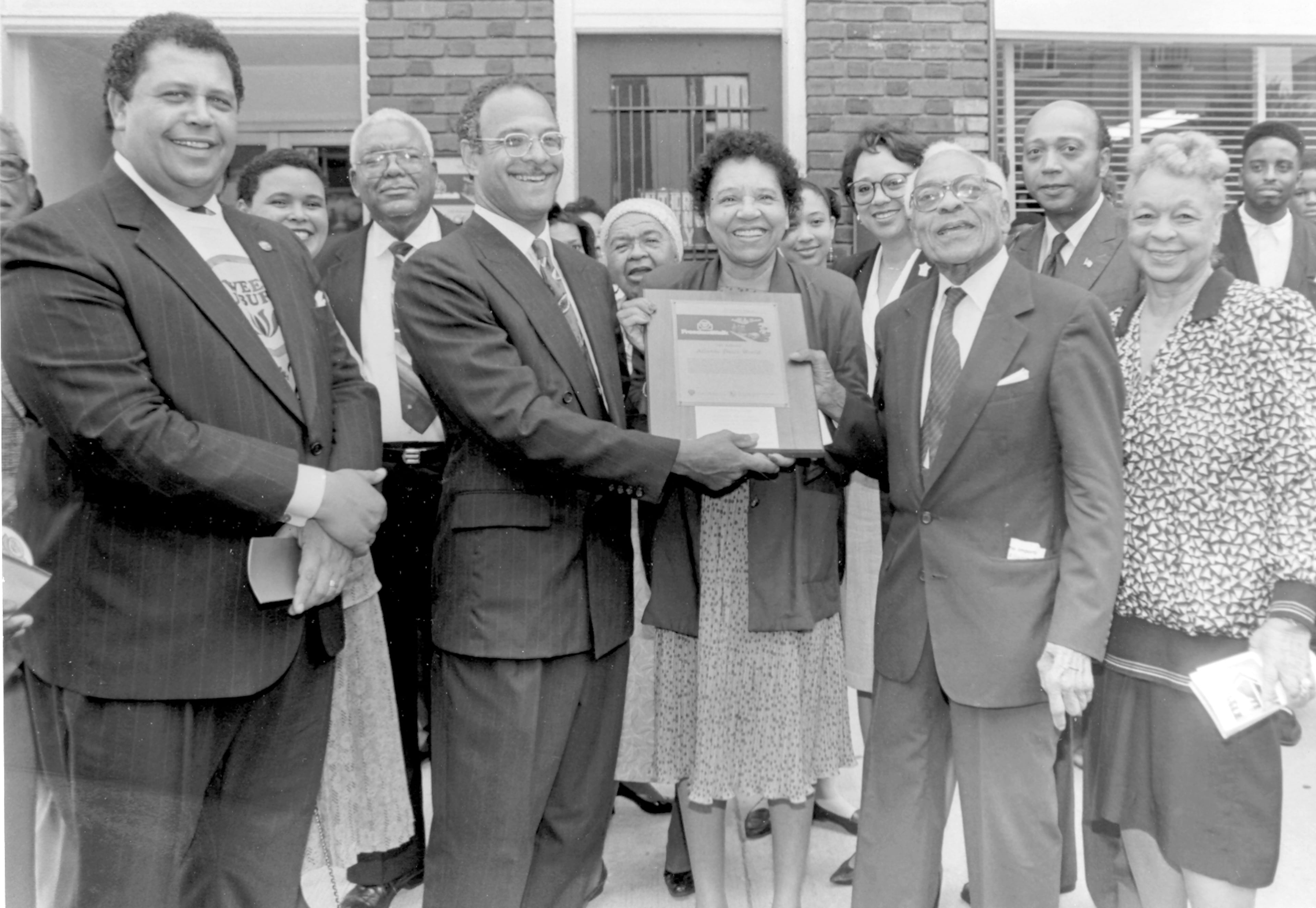 Former Atlanta mayors Maynard Jackson and Bill Campbell present former Atlanta Daily World publisher C.A. Scott with a marker designating the old Auburn Avenue Building a historic site. Several Scott family members are in the shot, including Alexis Scott, her father W.A. Scott III, Portia Scott and Wendell Scott