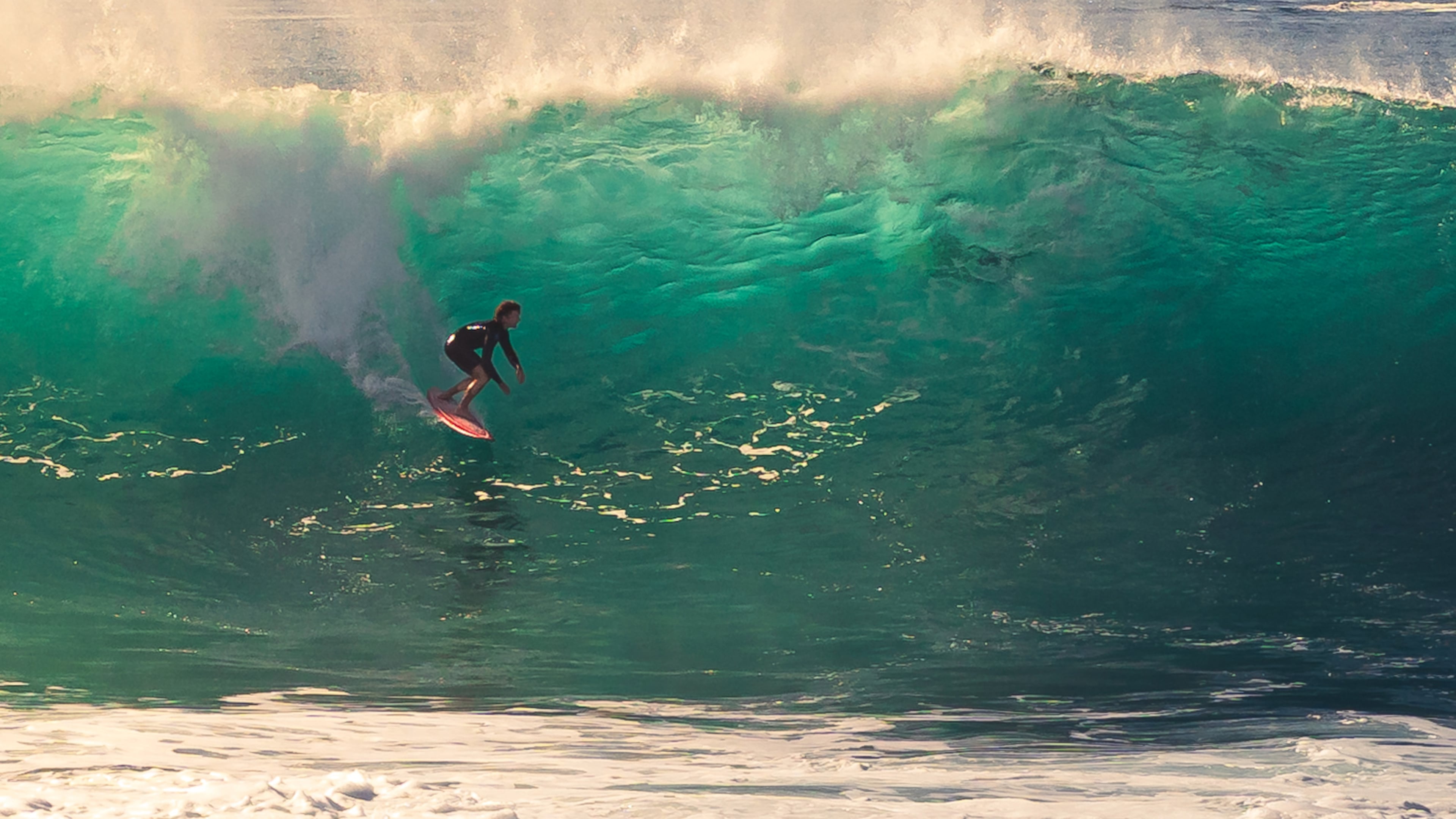 This photo provided by Steve Hague shows a surfer at Newport Beac, Saturday, Sept. 5, 2026, in Newport Beach, Calif. (Steve Hague via AP)