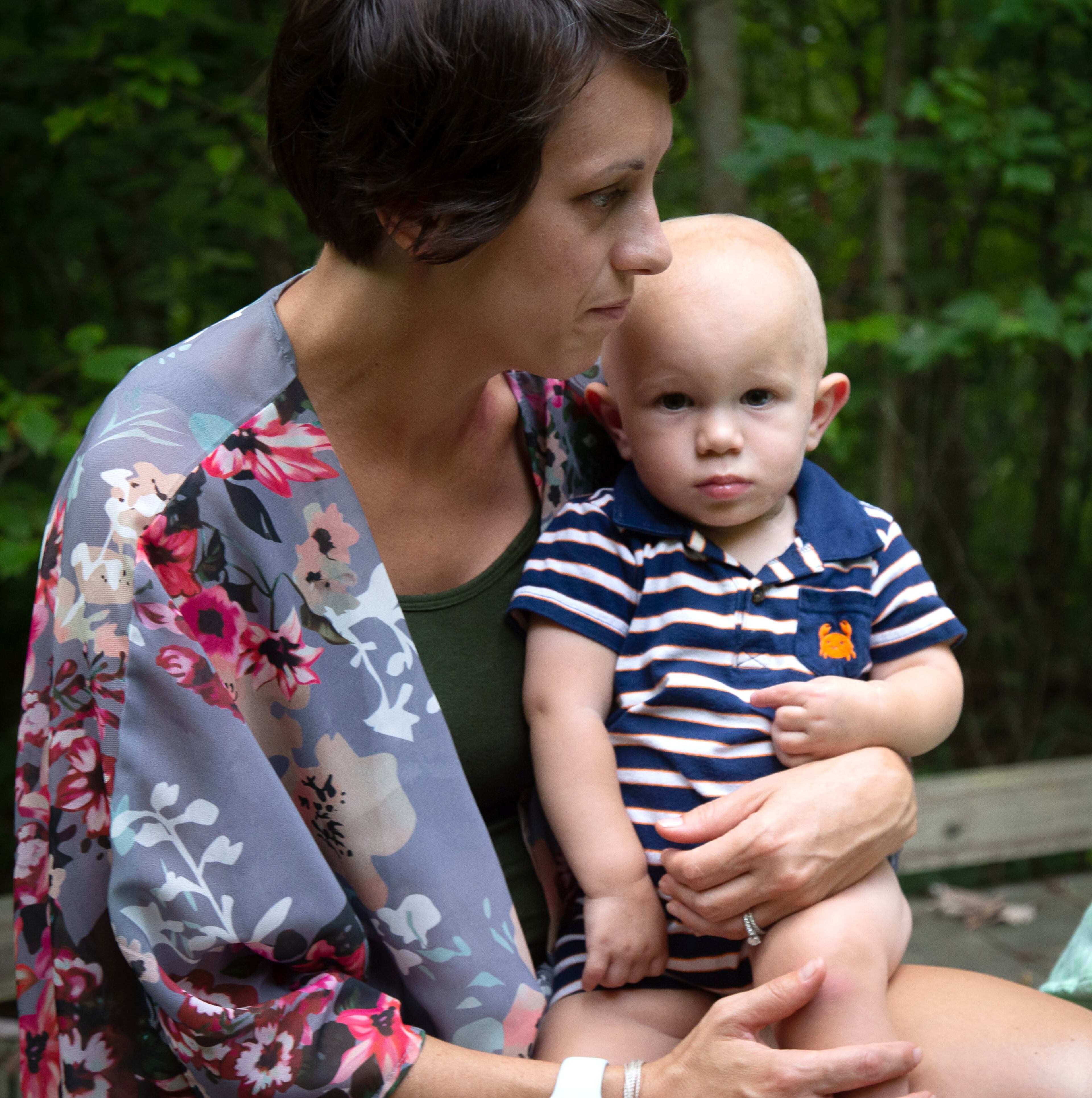 Angie Rush holds her son Carter while on a walk near her Marietta home on July 27, 2020. STEVE SCHAEFER FOR THE