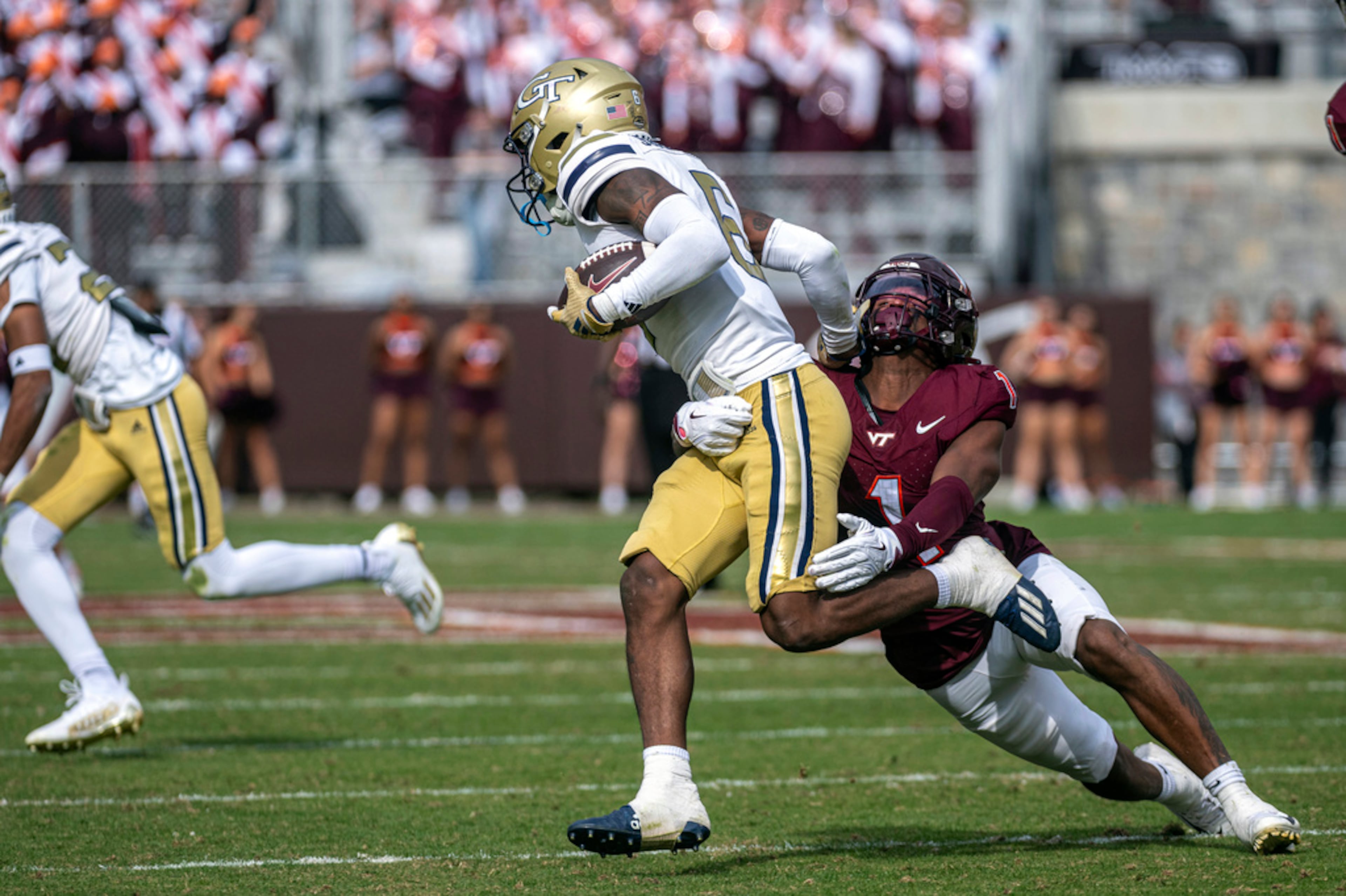 Virginia Tech's Dante Lovett (1) tackles Georgia Tech's punt returner Anthony Carrie (6) during the second half of an NCAA college football game, Saturday, Oct. 26, 2024, in Blacksburg, Va. (AP Photo/Robert Simmons)