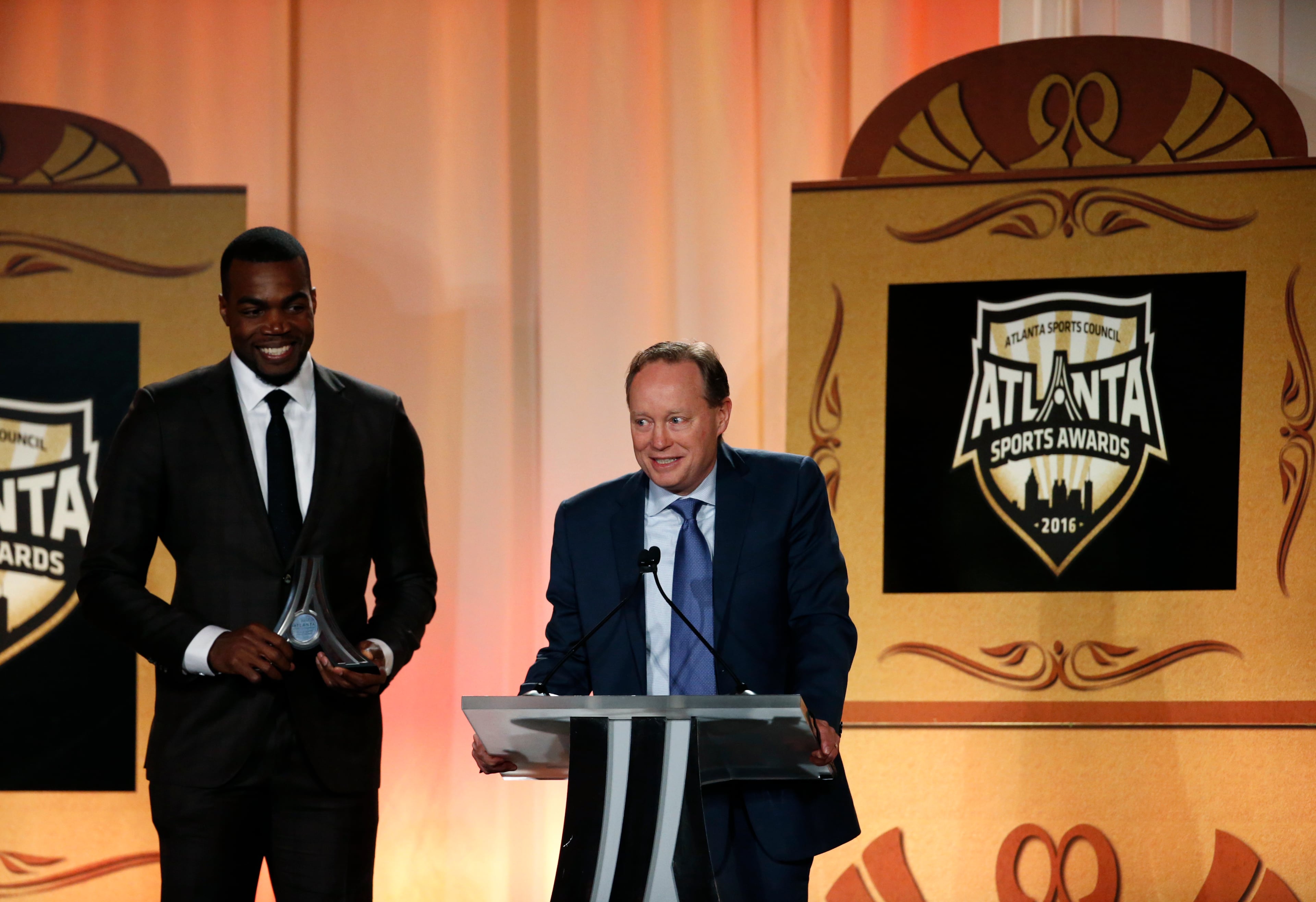 Atlanta Hawks head coach Mike Budenholzer speaks next to Atlanta Hawks forward Paul Millsap as they receive the Team of the Year award during the Atlanta Sports Awards at the Fox Theatre Thursday, February 25, 2016, in Atlanta. PHOTO / JASON GETZ