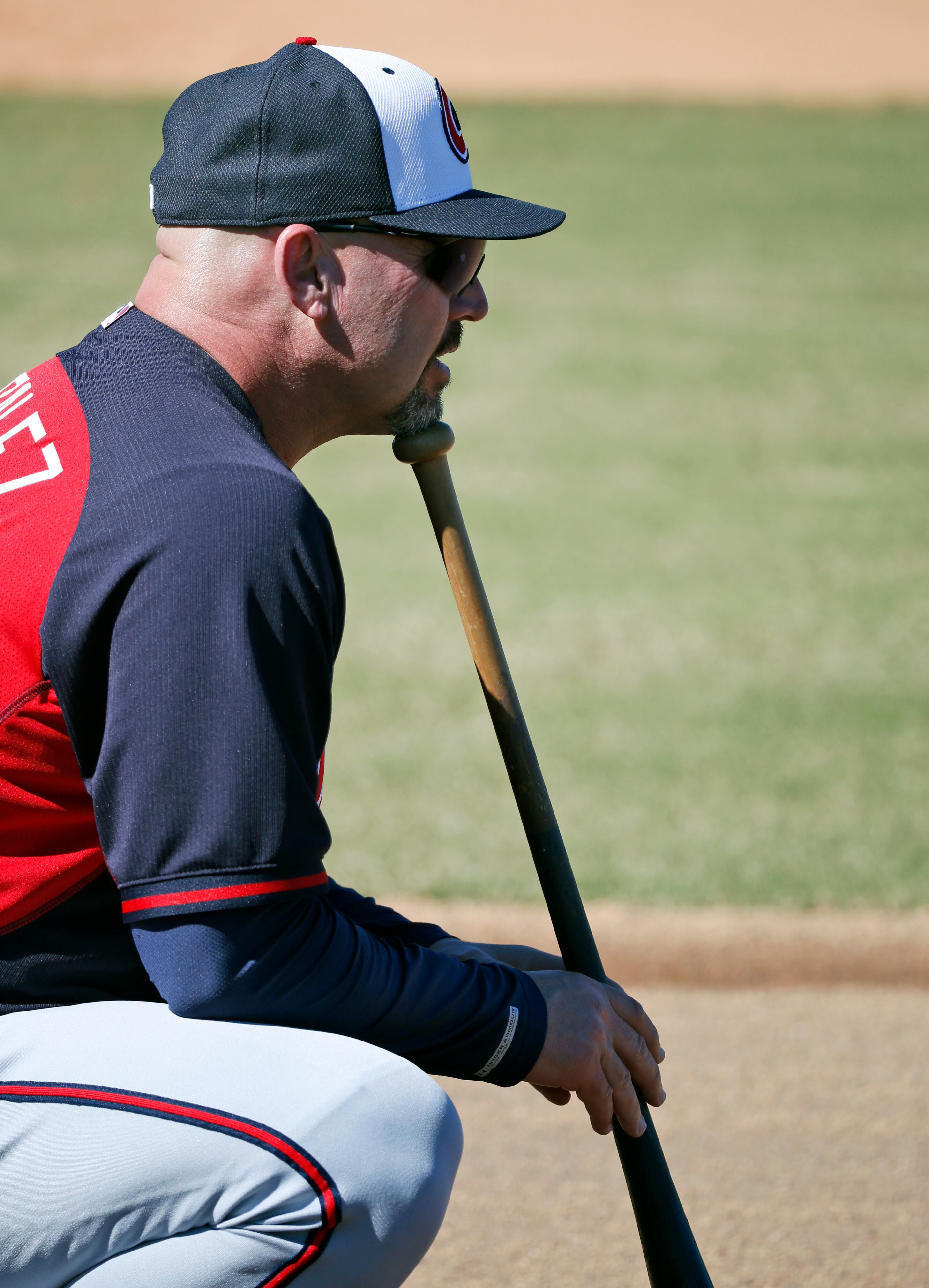 Atlanta Braves manager Fredi Gonzalez leans on a bat as he watches his team during a spring training baseball workout, Sunday, Feb. 16, 2014, in Kissimmee, Fla. (AP Photo/Alex Brandon)