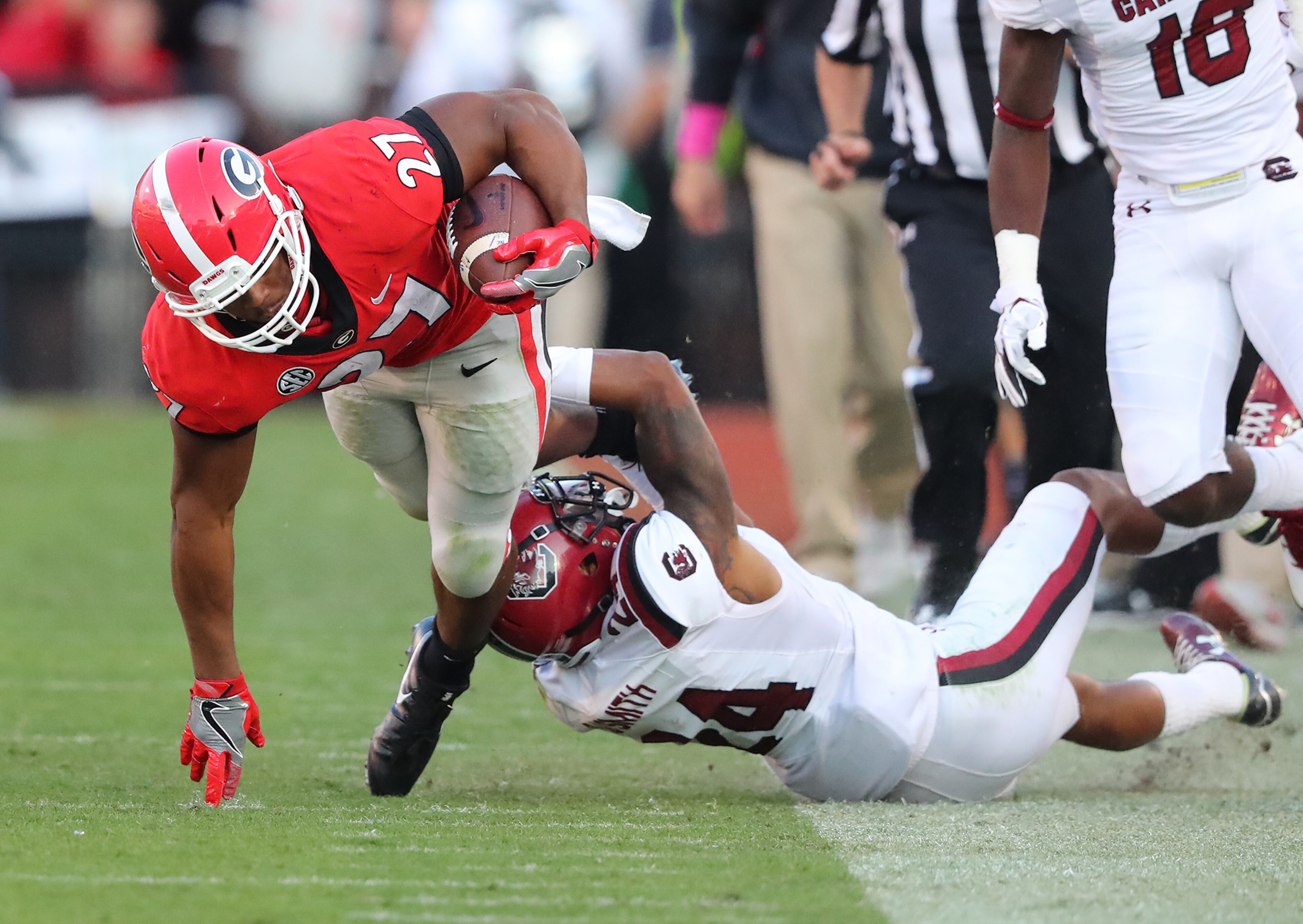 November 4, 2017 Athens: Georgia tailback Nick Chubb makes a 27-yard gain against South Carolina as he is tackled by D.J. Smith during the third quarter in a NCAA college football game on Saturday, November 4, 2017, in Athens. Curtis Compton/ccompton@ajc.com