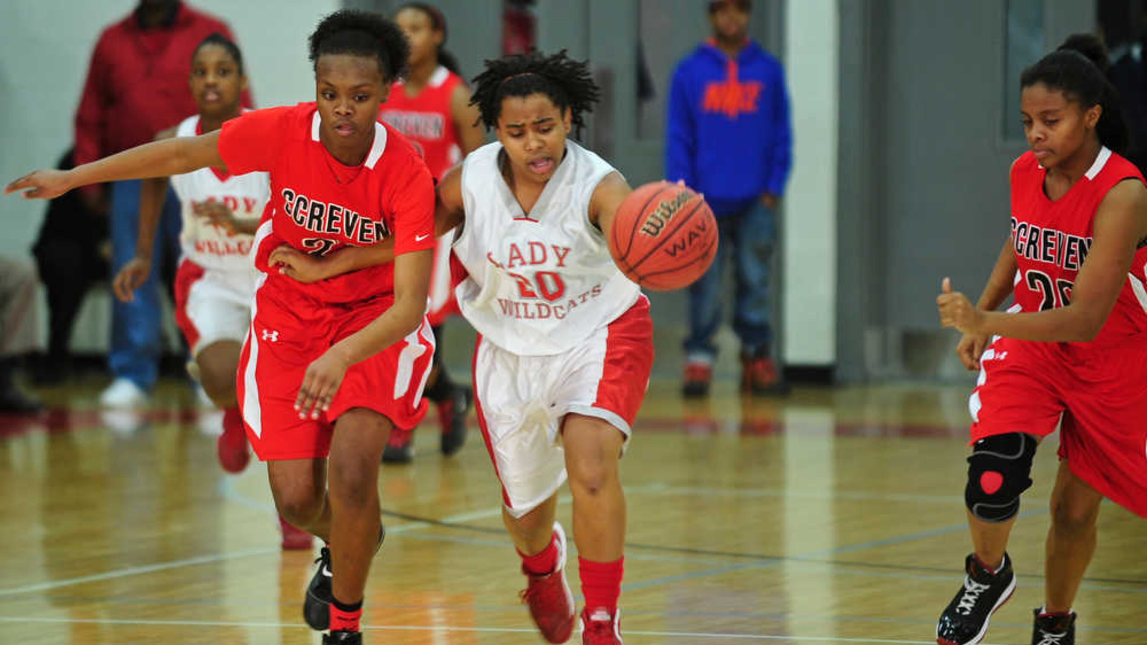 Two Screven County defenders chase after a dribbling Laney Lady Wildcats player in their game during the 2013 season. (Photo courtesy of The Augusta Chronicle)