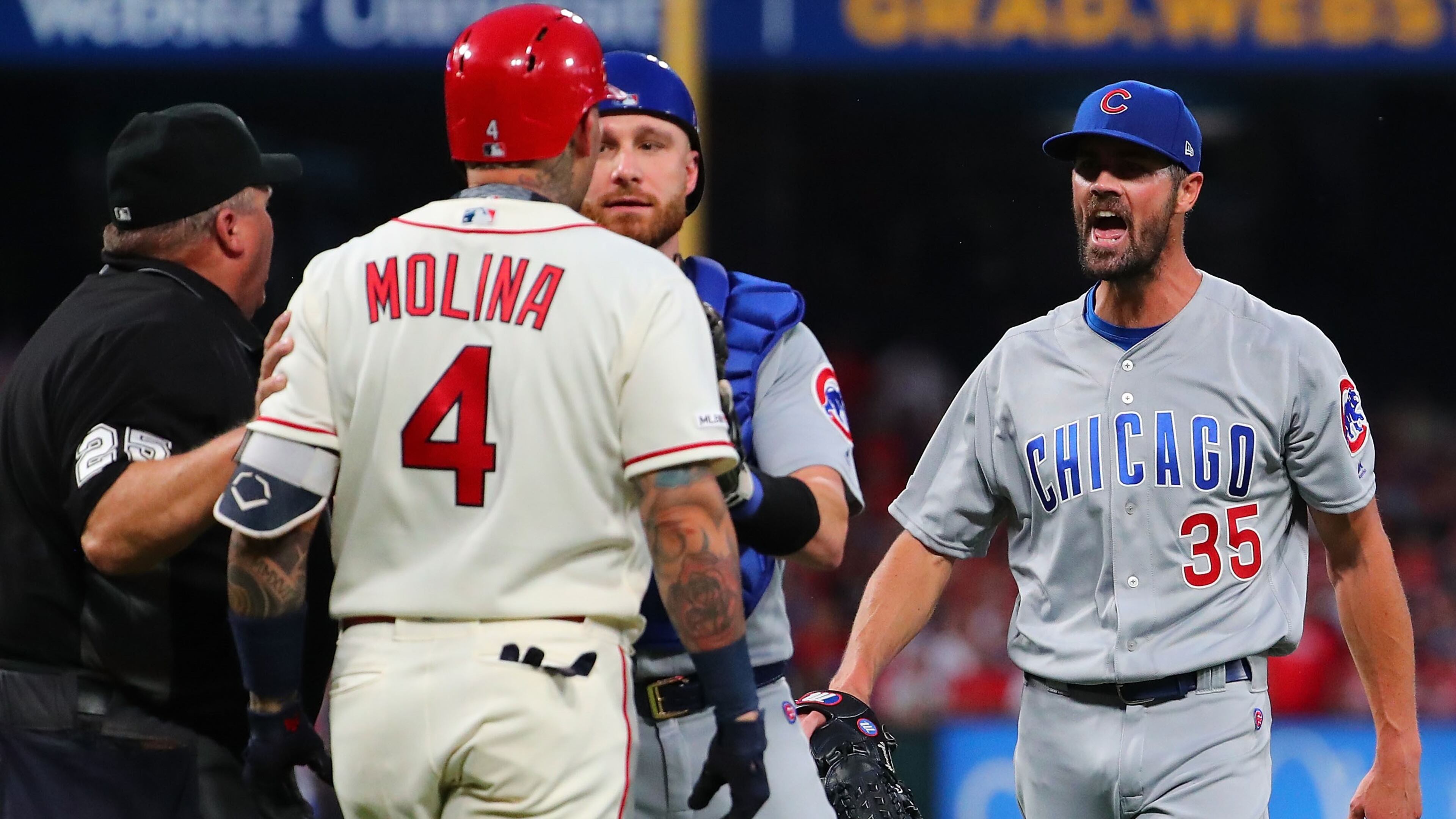 Jonathan Lucroy of the Chicago Cubs restrains Yadier Molina of the St. Louis Cardinals as he confronts Cole Hamels of the Chicago Cubs after he hit Molina with a pitch in the second inning at Busch Stadium on September 28, 2019 in St Louis, Missouri. (Photo by Dilip Vishwanat/Getty Images)