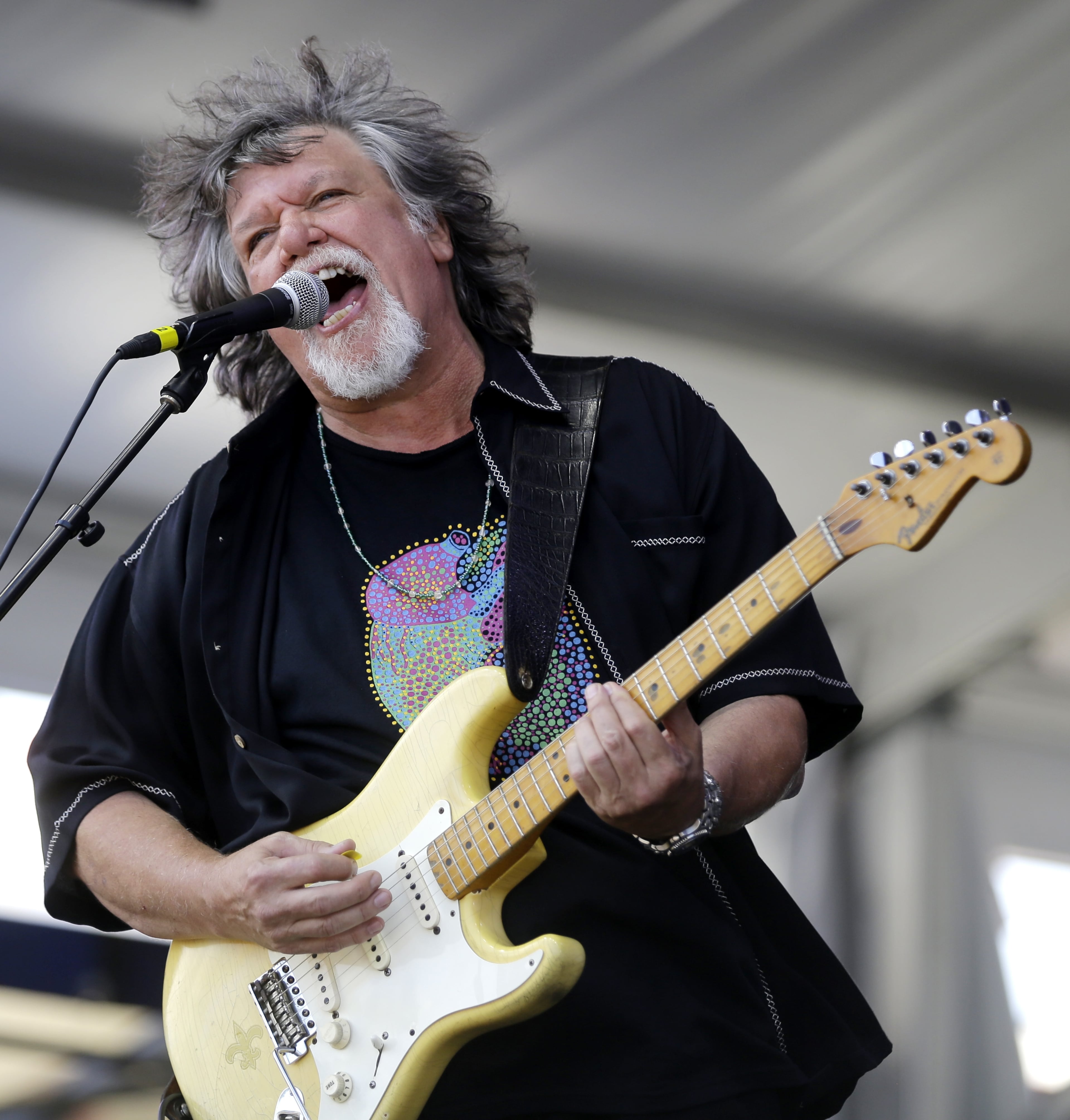 Dave Malone of the Radiators plays with the band at the New Orleans Jazz and Heritage Festival in New Orleans, Sunday, May 3, 2015. (AP Photo/Gerald Herbert)