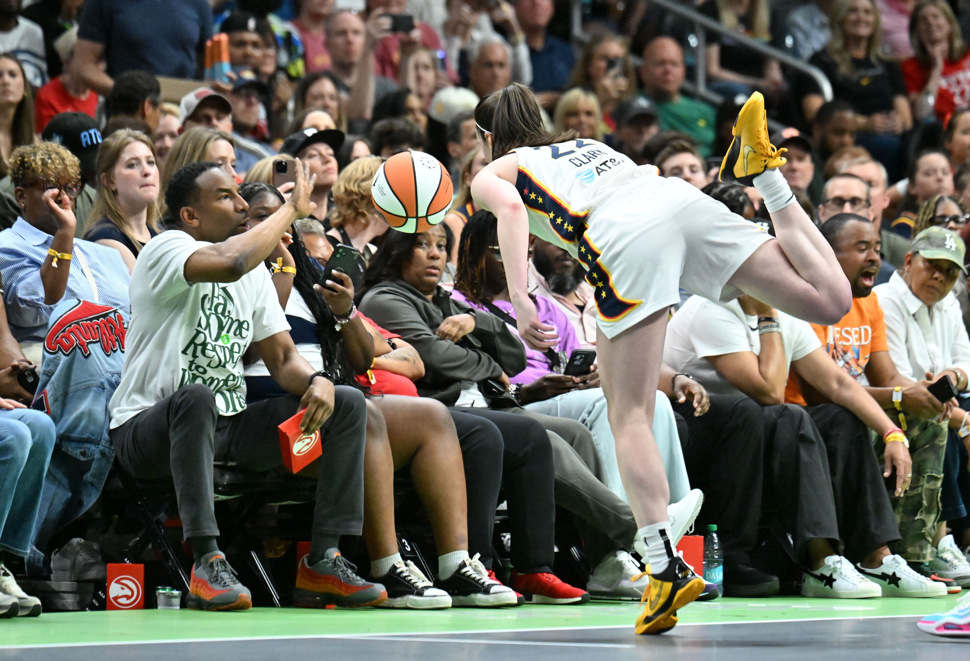 Atlanta mayor Andre Dickens stops the outbound ball as Indiana Fever guard Caitlin Clark (22) chases down during the first half in Atlanta Dream’s home opener at State Farm Arena, Thursday, May 22, 2025, in Atlanta. (Hyosub Shin / AJC)