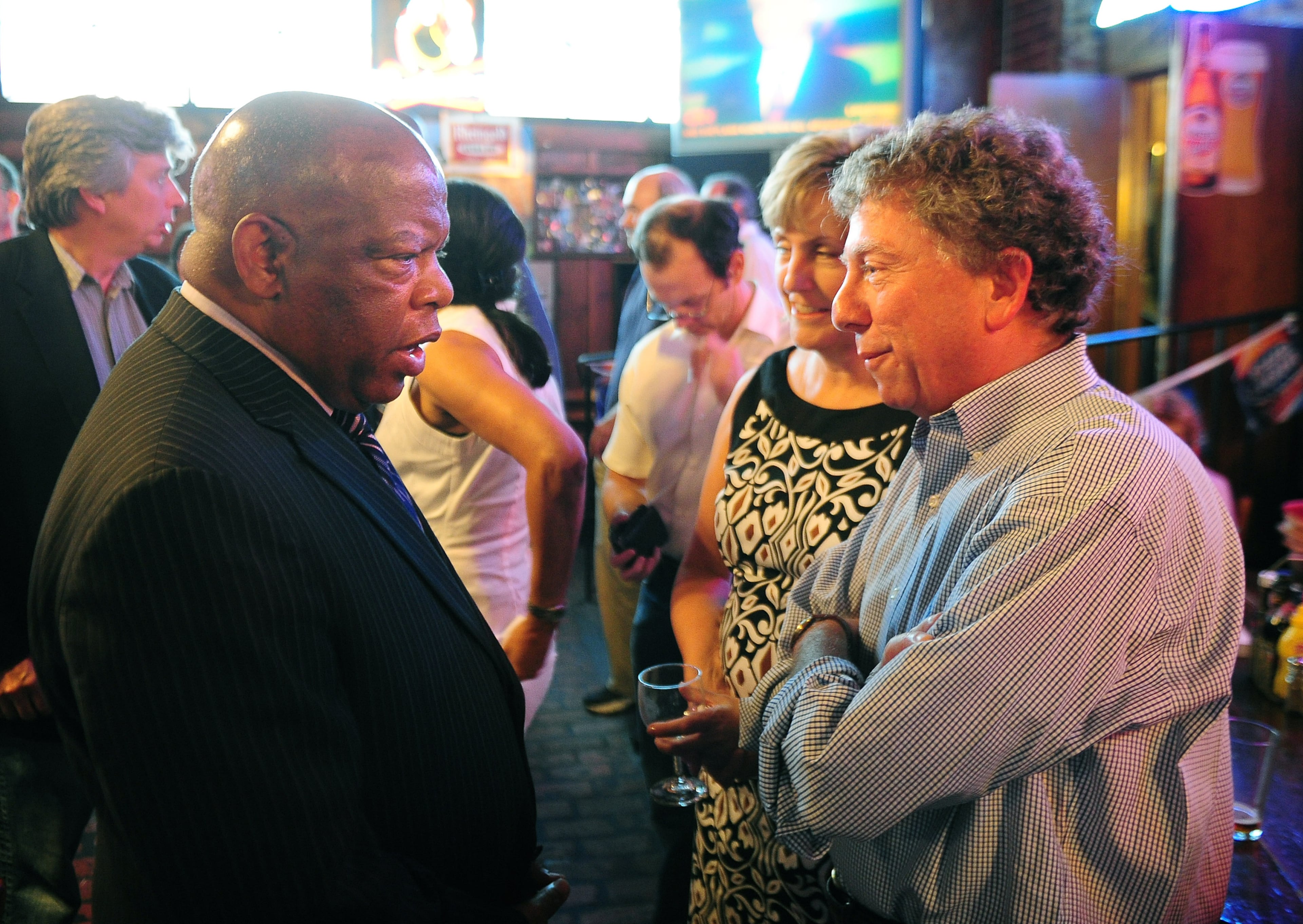 Rep. John Lewis and former AJC Managing Editor Hank Klibanoff chat during Klibanoff's send off party at Manuel's Tavern in June 2008. Pouya Dianat/AJC