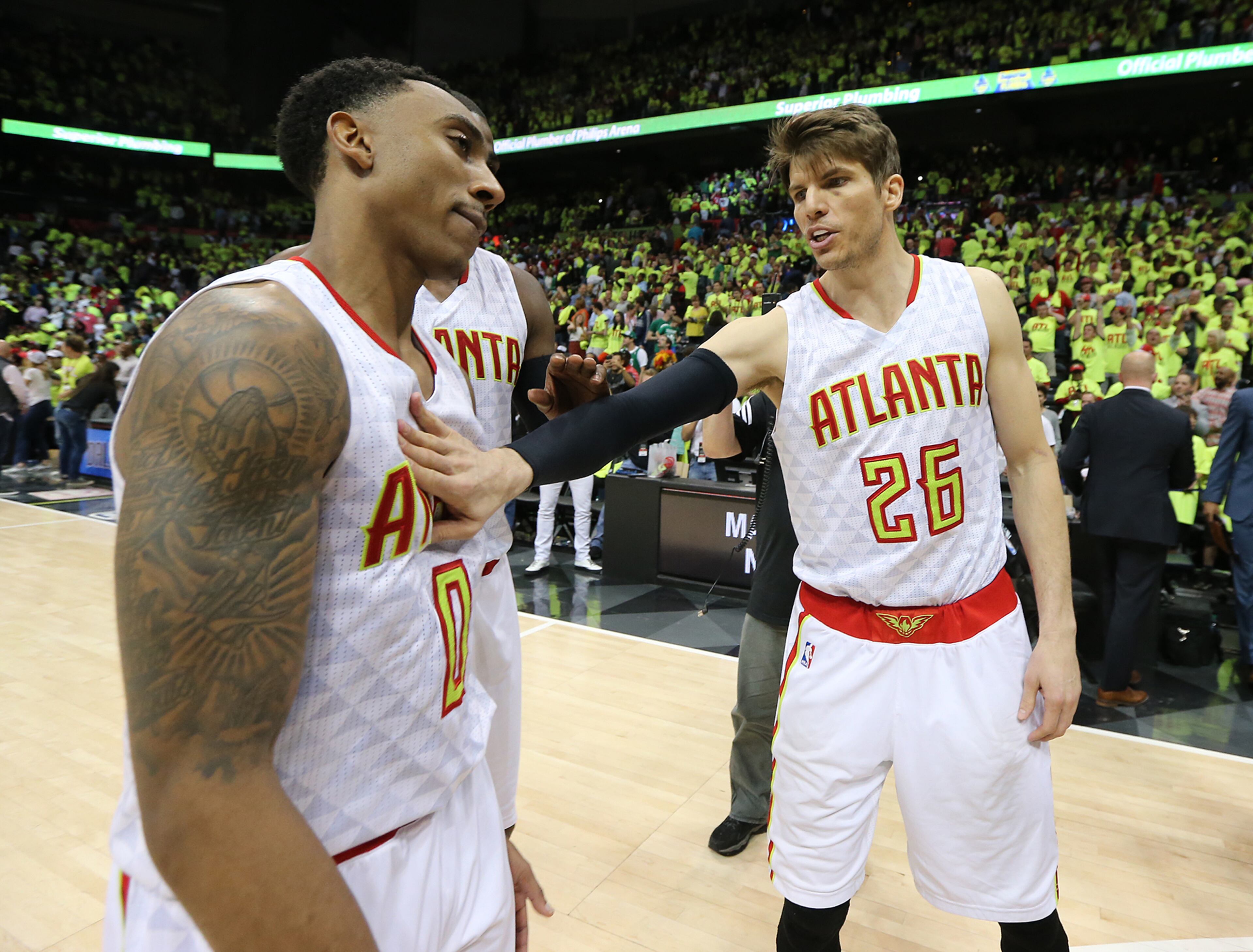 041616 ATLANTA: Jeff Teague (left) gets a pat on the chest from Kyle Korver as the Hawks beat the Celtics 102-101 in game one of their NBA Eastern Conference first round playoff game at Philips Arena on Saturday, April 16, 2016. Curtis Compton / ccompton@ajc.com