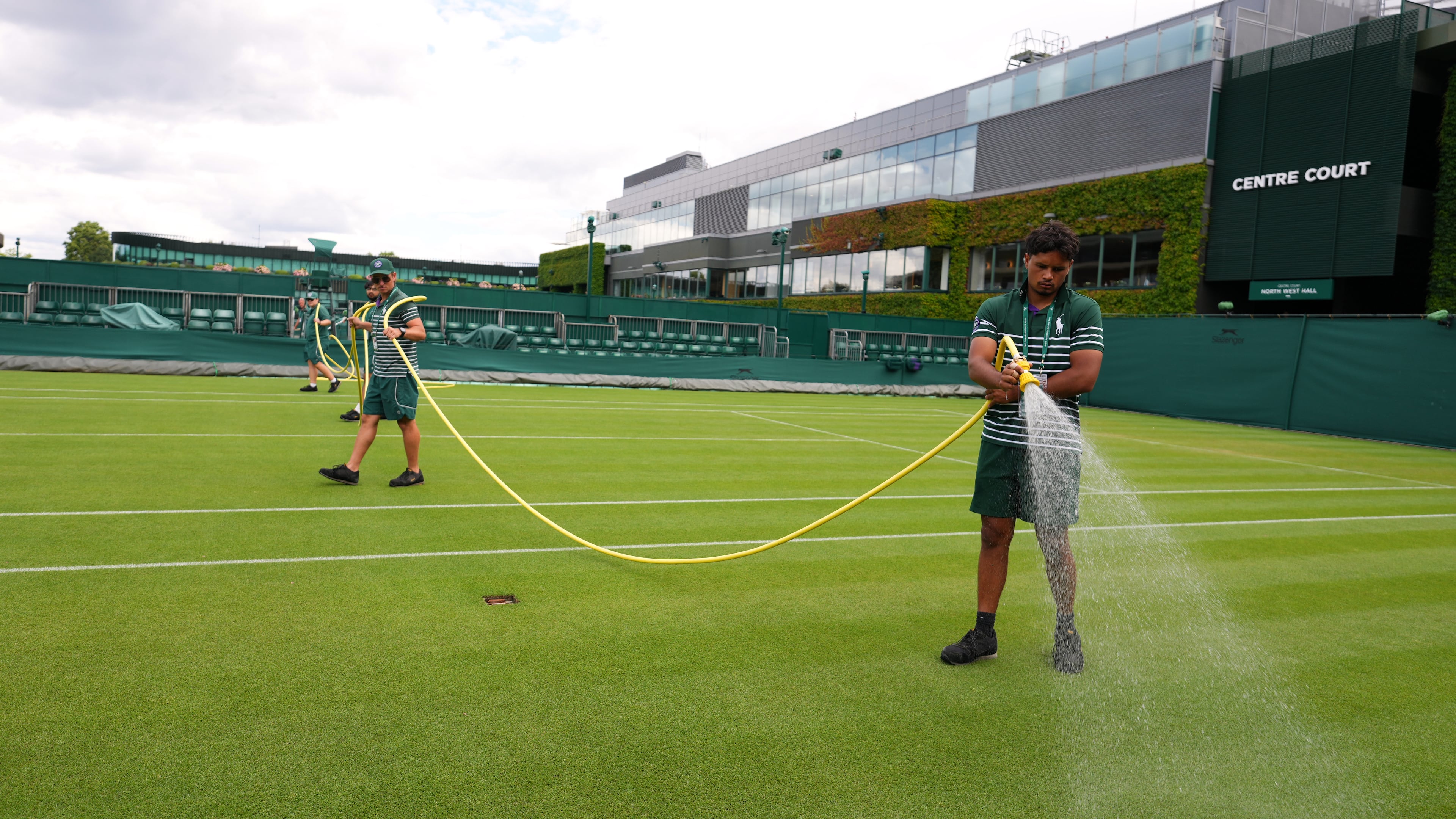 Ground staff waters a court one day ahead of the start of the Wimbledon Tennis Championships in London, Sunday, June 28, 2026.(AP Photo/Kirsty Wigglesworth)