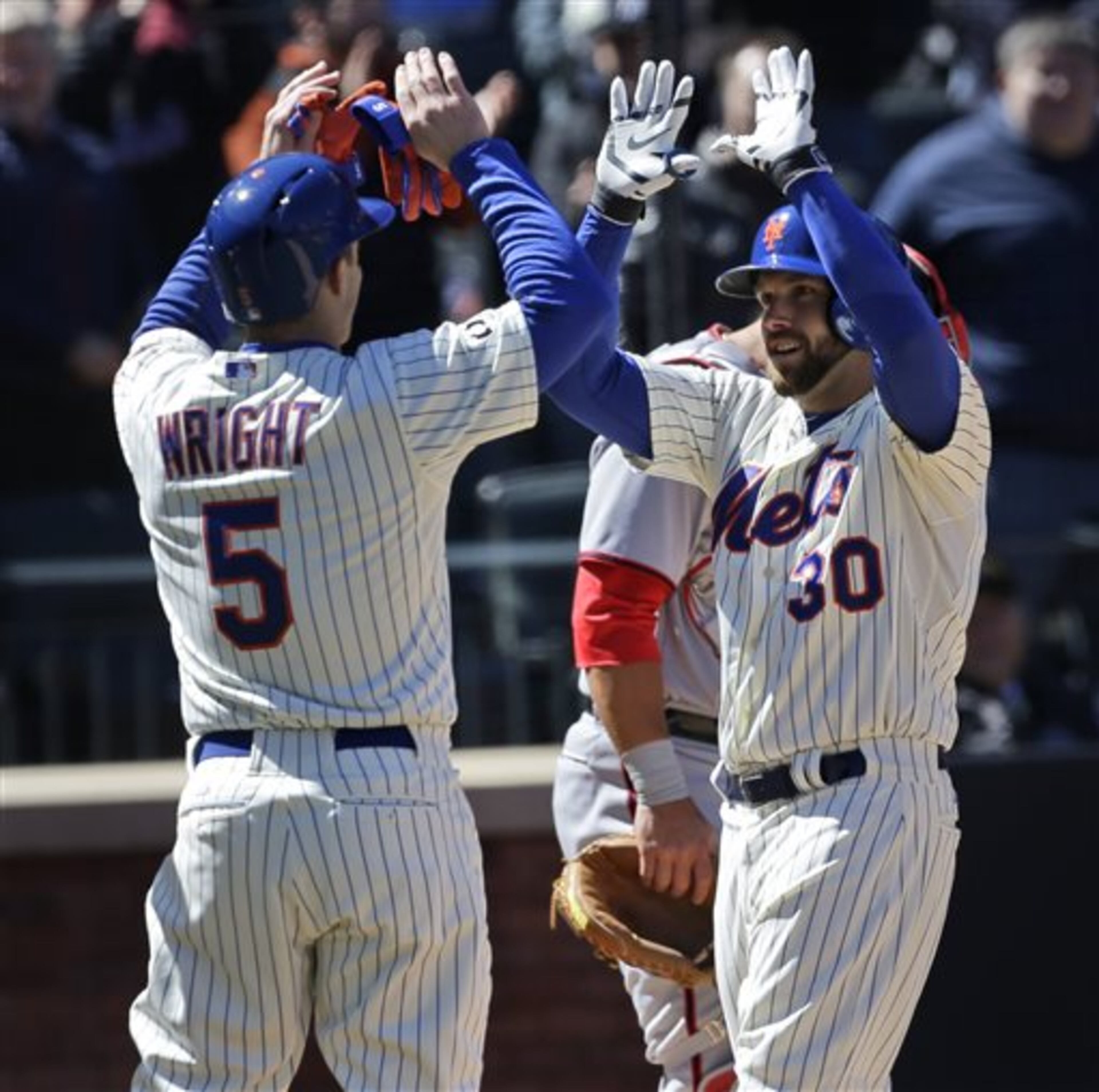 New York Mets' Andrew Brown, right, is greeted at home plate by David Wright after Brown hit a three-run homer during the first inning of the baseball game against the Washington Nationals on opening day at Citi Field in New York, Monday, March 31, 2014. (AP Photo/Seth Wenig)