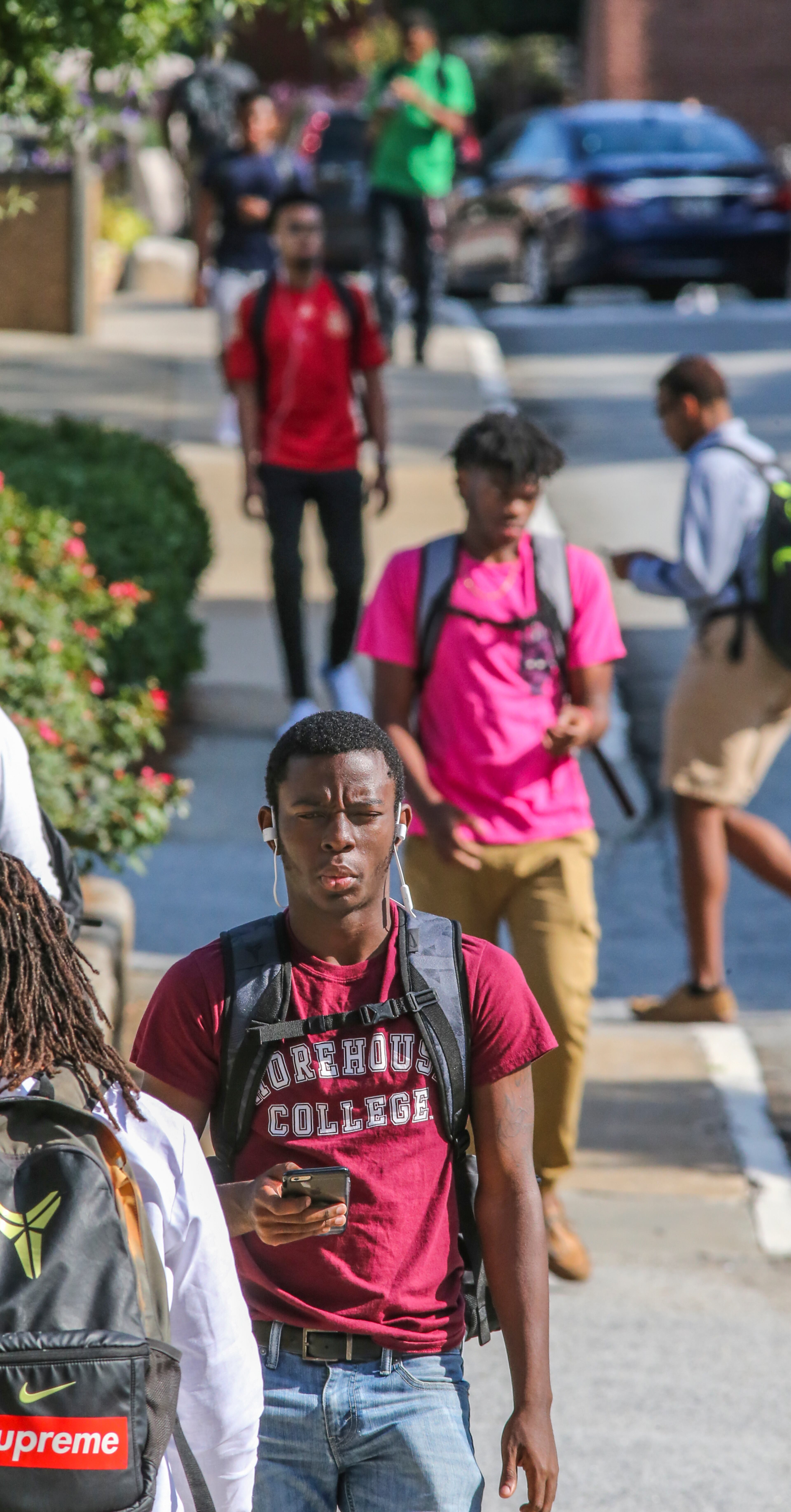 Thomas Hammond, 19, a freshman from Baltimore, walks down Brown Street as he heads to class. Hammond said he was listening to Rihanna's "Work." The Morehouse student body enrollment is 2,100, with more than 730 students who will make up the freshman class graduating in 2020.