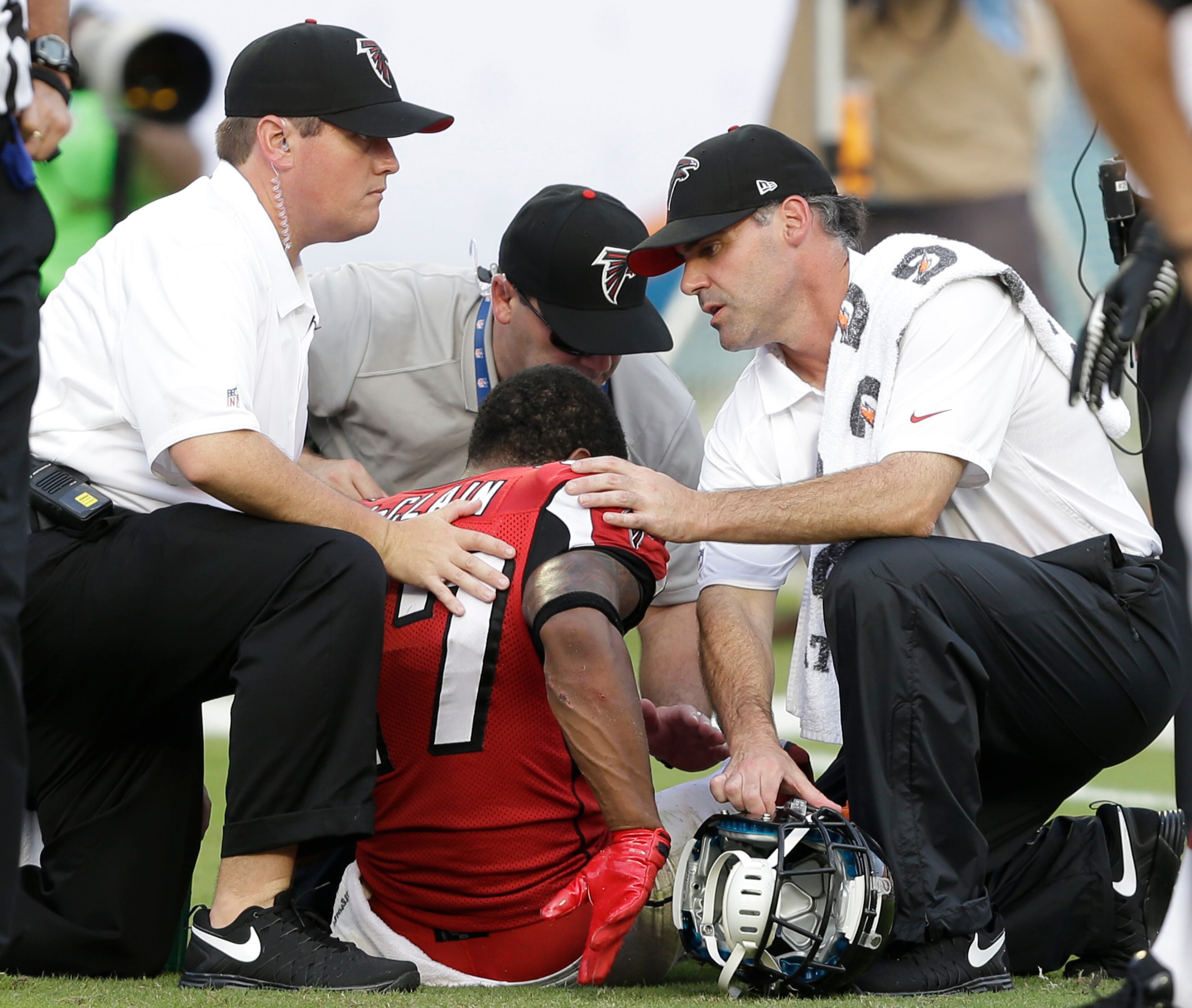 Atlanta Falcons cornerback Robert McClain is attended to after a play during the second half of an NFL football game against the Miami Dolphins, Sunday, Sept. 22, 2013, in Miami Gardens, Fla. The Dolphins defeated the Falcons 27-23. (AP Photo/Wilfredo Lee)