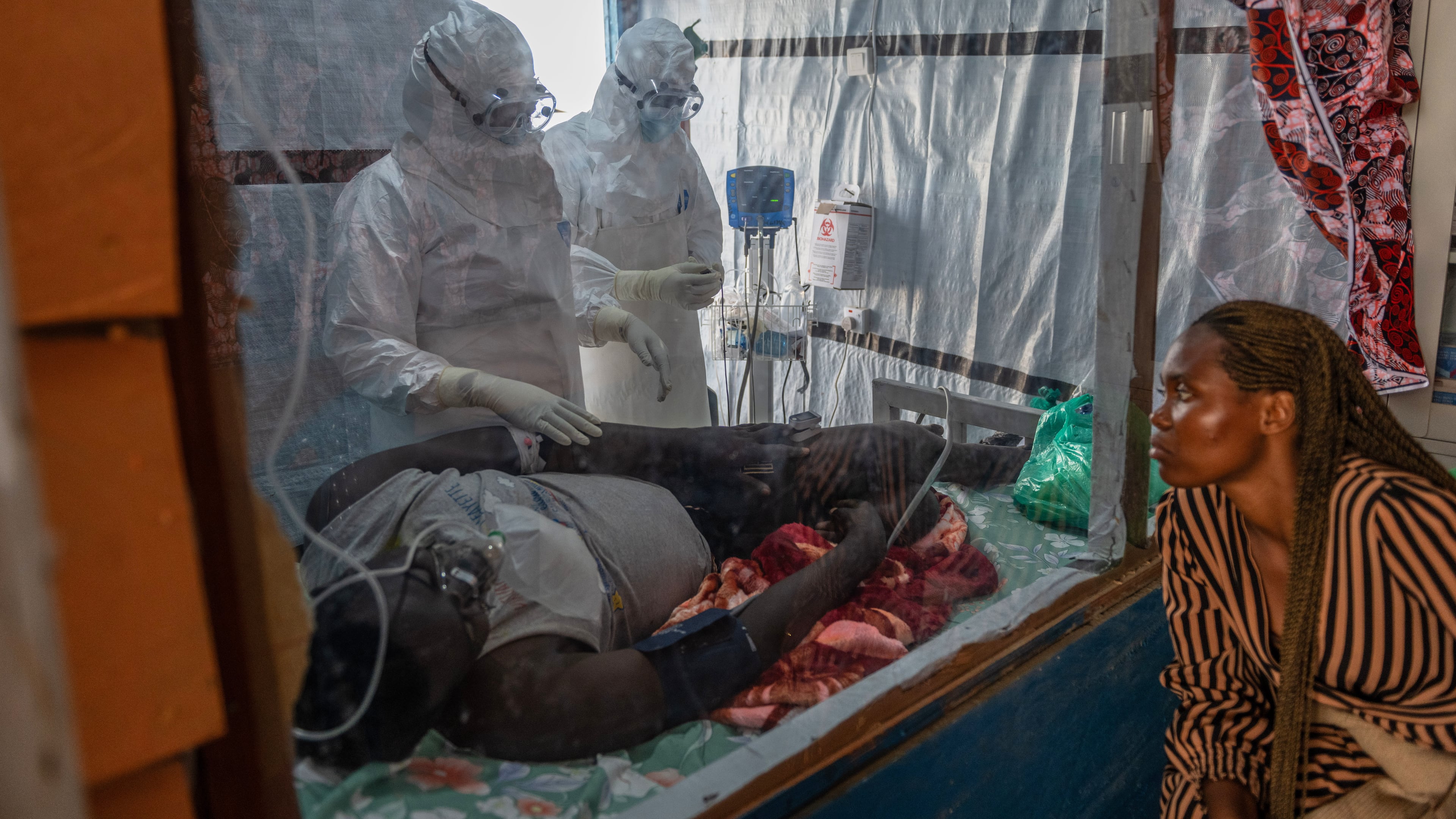 Health workers tend to an Ebola patient at the Rwampara Treatment Center in Ituri, Congo, Thursday, June 18, 2026. (AP Photo/Moses Sawasawa)