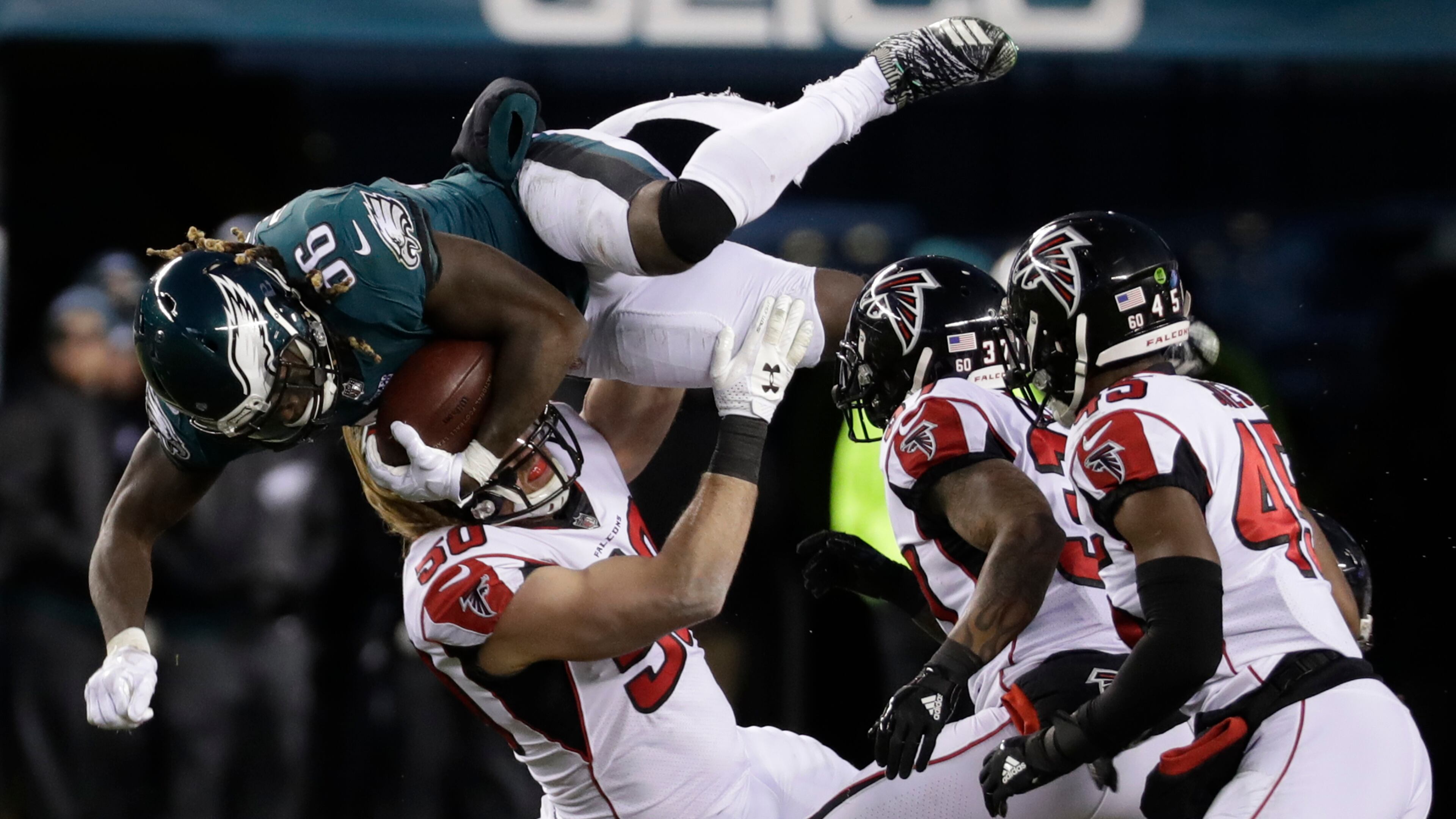 Philadelphia Eagles' Jay Ajayi (36) is tackled by Atlanta Falcons' Brooks Reed (50) during the first half of an NFL divisional playoff football game, Saturday, Jan. 13, 2018, in Philadelphia.