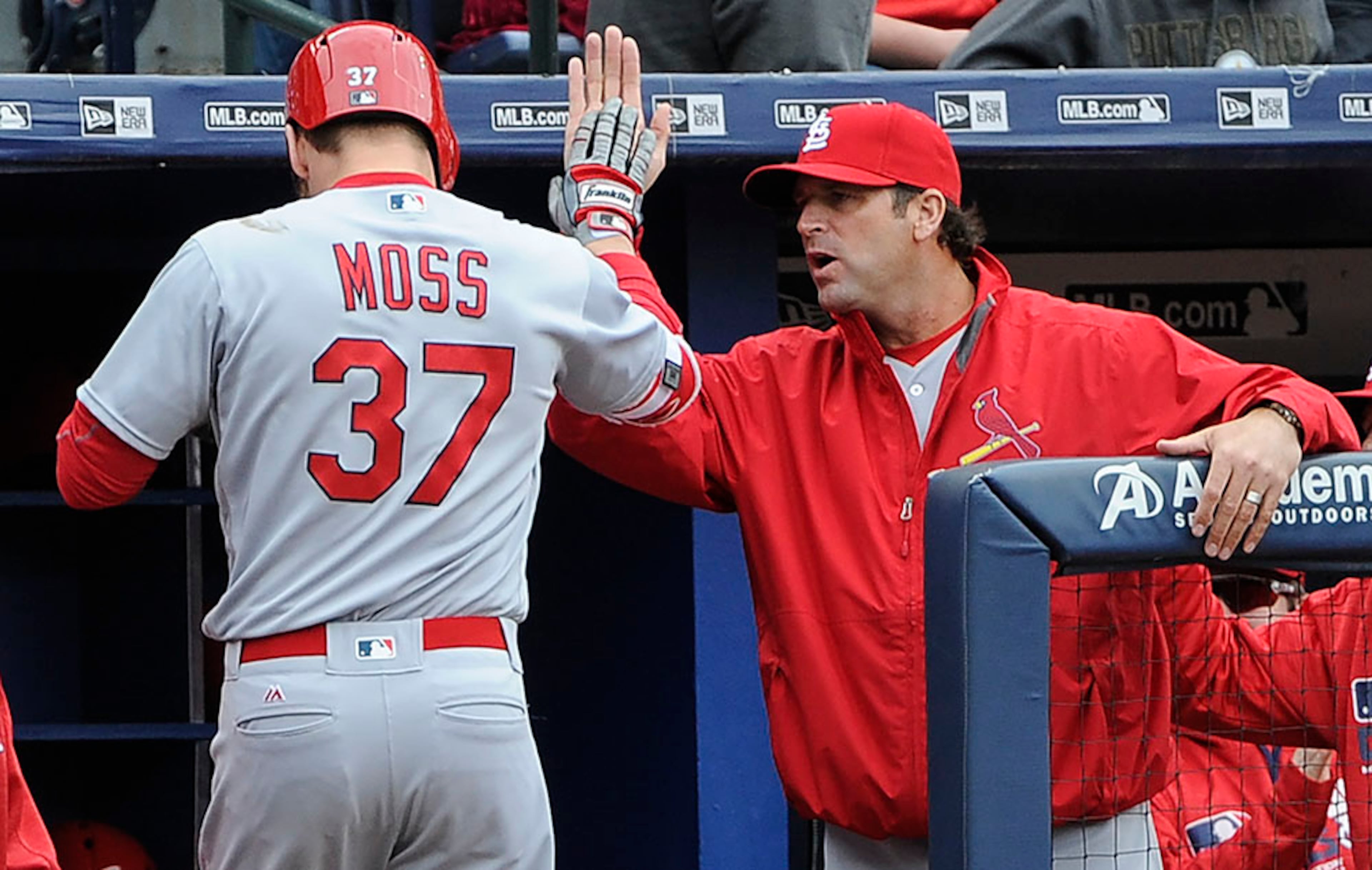St. Louis Cardinals' Brandon Moss is congratulated as he comes to the dugout by manager Mike Matheny (right) after hitting a three run home run against the Atlanta Braves during the third inning Sunday, April 10, 2016, in Atlanta.