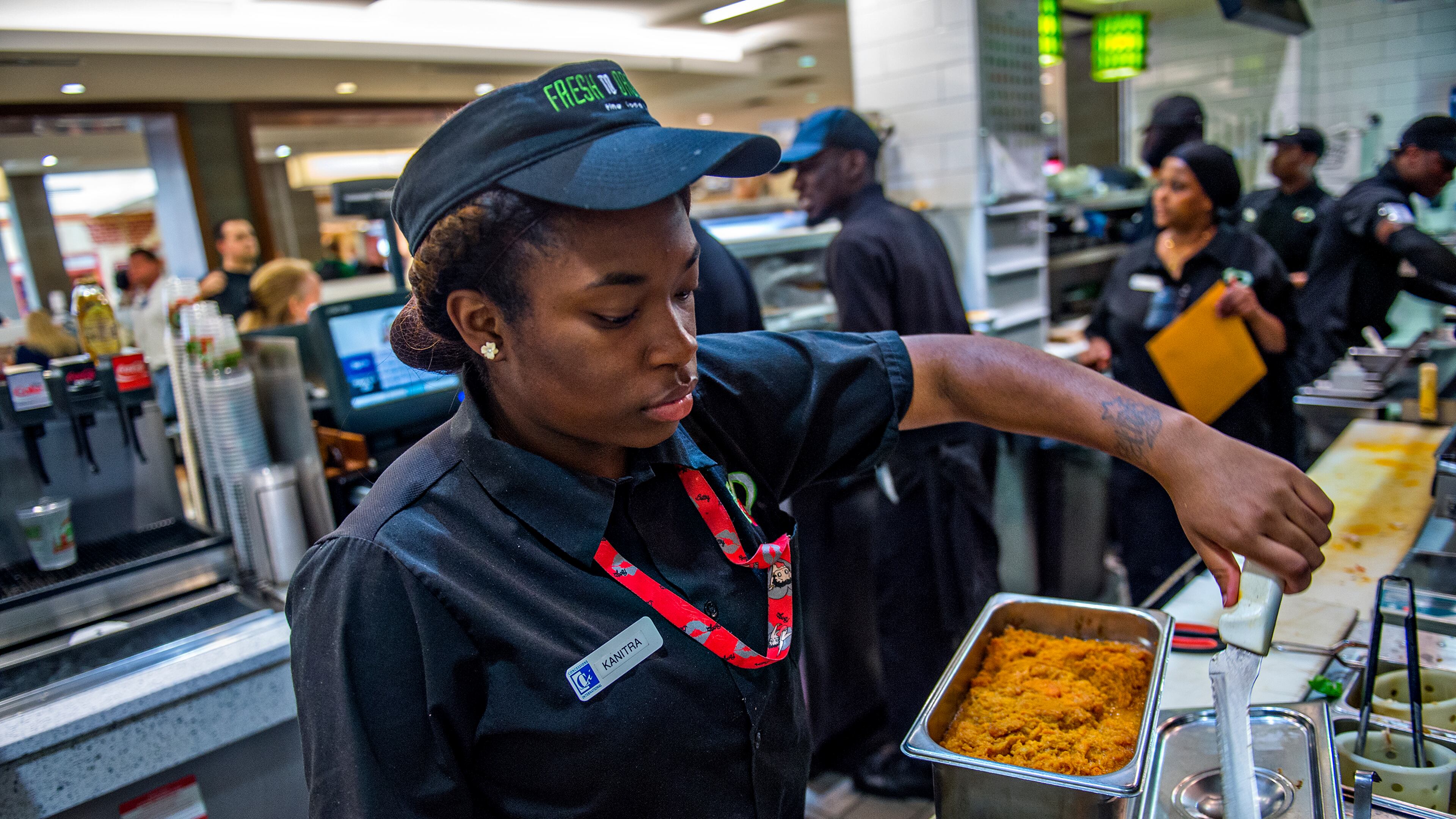 September 2, 2015 Atlanta - Kanitra Williams (left) uses a tethered knife at Fresh to Order inside the Hartsfield Jackson Atlanta International Airport on Wednesday, September 2, 2015. Restaurants inside the airport have challenges including limited space, tethered knives, mandatory knife inventory inspections and electric grills. JONATHAN PHILLIPS / SPECIAL