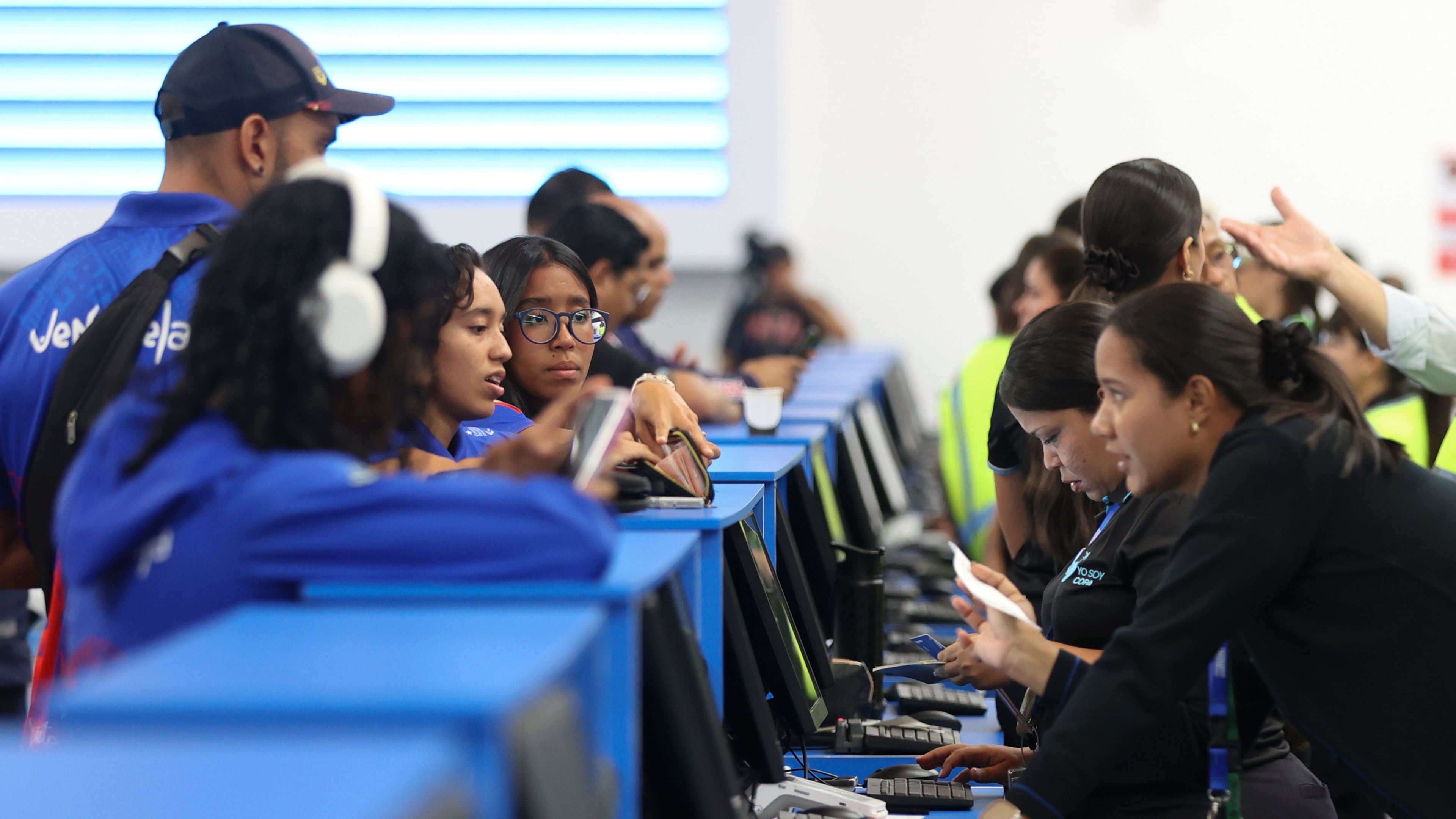 Passengers check in at Simon Bolivar International Airport as it reopens to commercial flights two months after closing due to the earthquake in Maiquetia, Venezuela, Tuesday, Sept. 1, 2026. (AP Photo/Pedro Mattey)