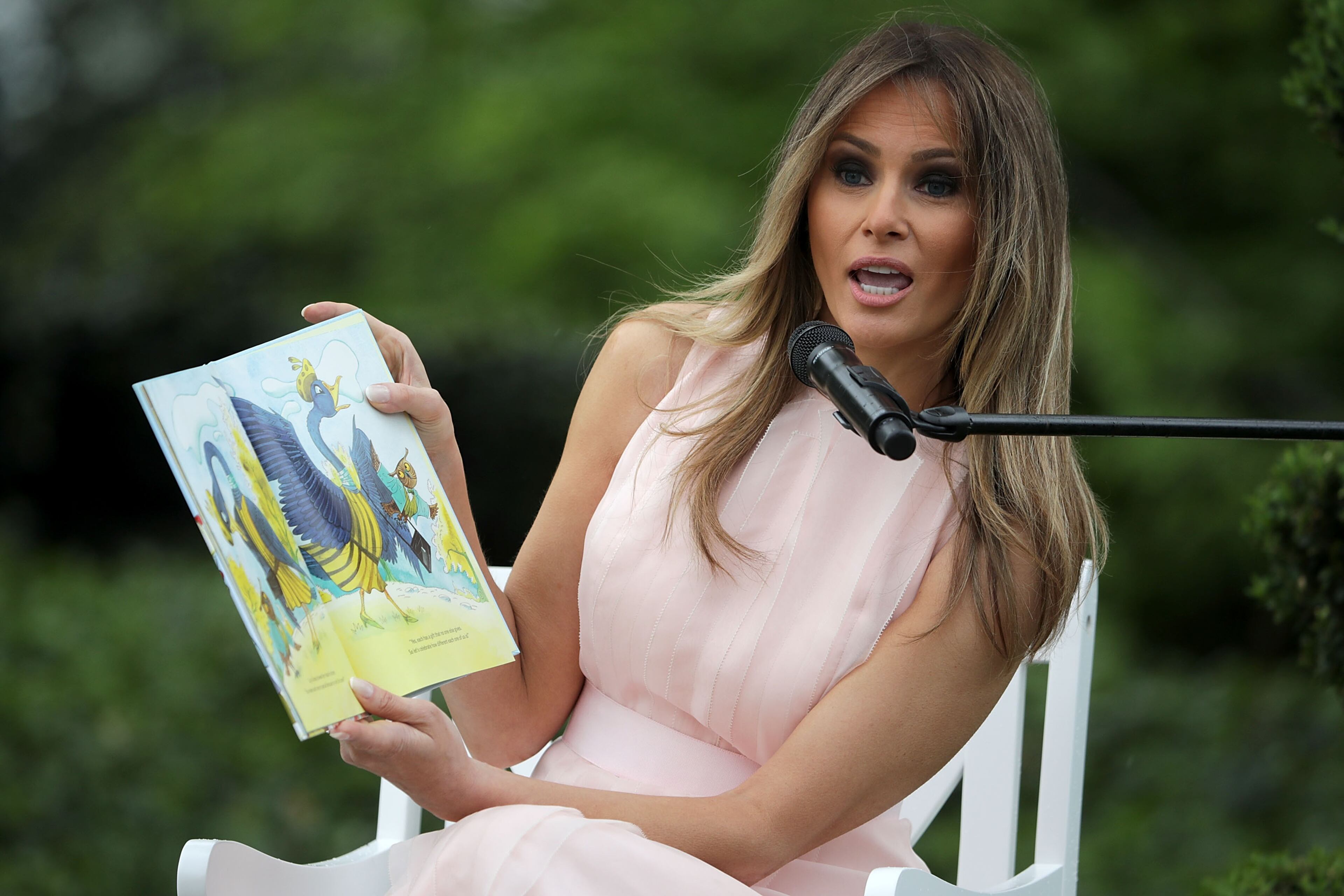 WASHINGTON, DC - APRIL 17: U.S. first lady Melania Trump reads 'Party Animals' by Kathy Lee Gifford during the 139th Easter Egg Roll on the South Lawn of the White House April 17, 2017 in Washington, DC. The White House said 21,000 people are expected to attend the annual tradition of rolling colored eggs down the White House lawn that was started by President Rutherford B. Hayes in 1878. (Photo by Chip Somodevilla/Getty Images)