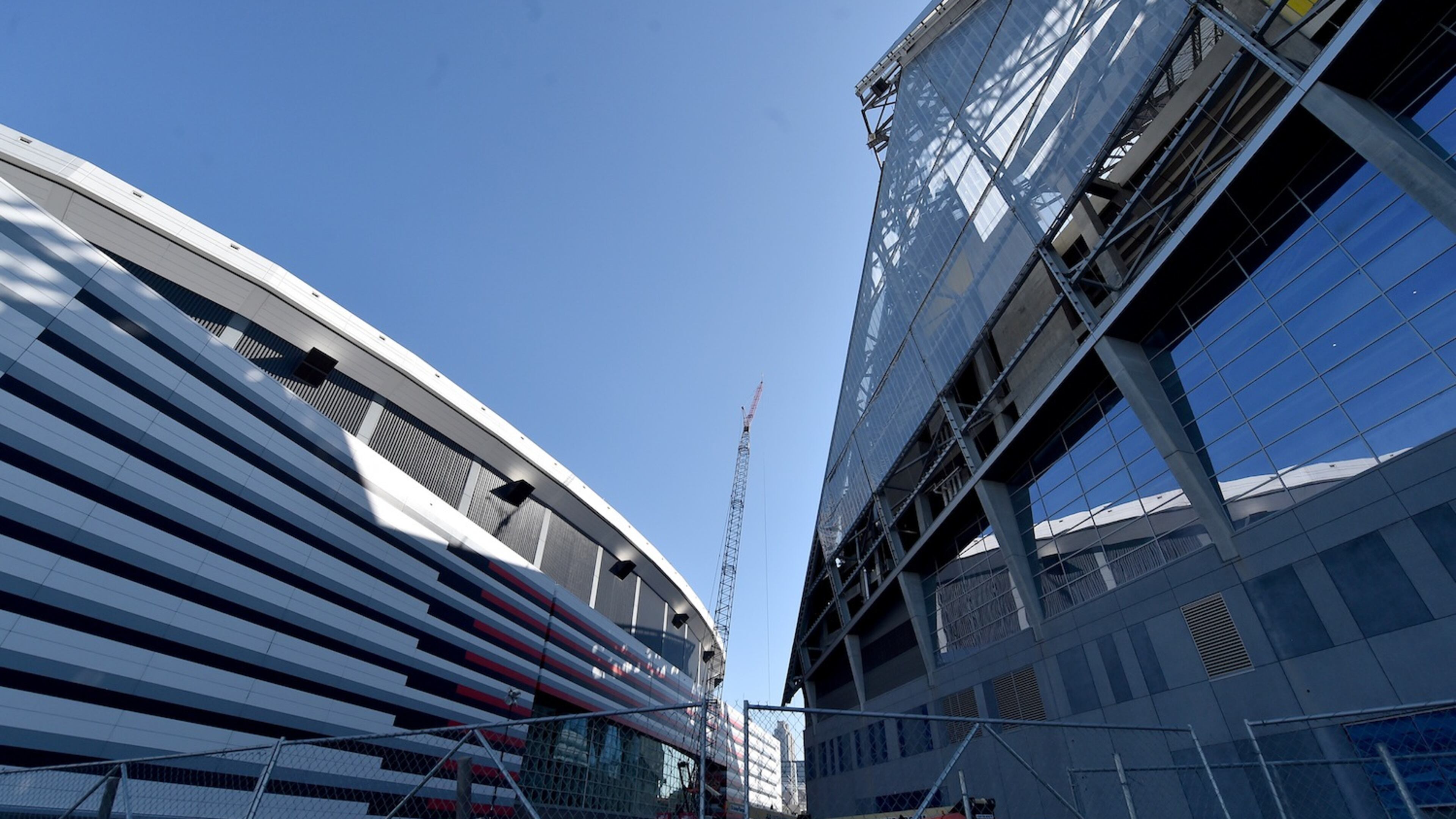 The new Falcons stadium overshadows the Georgia Dome as construction continues. Construction crews celebrated the near completion of the the fixed roof at Mercedes Benz Stadium Wednesday October 19, 2016 by signing a beam and then lifting it into place. The completed stadium will use more than 27,000 tons of steel. Installation of the retractable roof will begin next. BRANT SANDERLIN/BSANDERLIN@AJC.COM