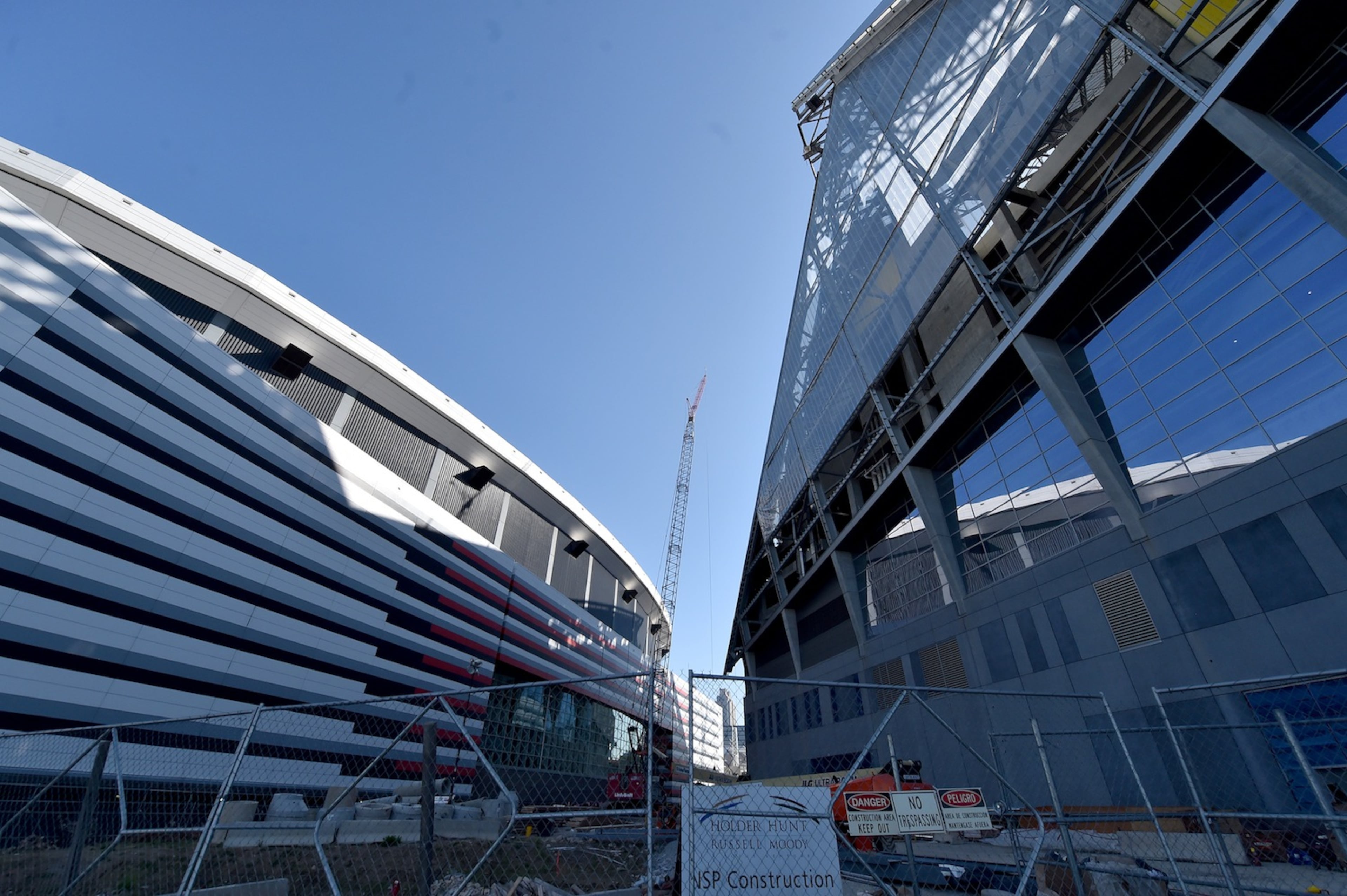 The new Falcons stadium overshadows the Georgia Dome as construction continues. Construction crews celebrated the near completion of the the fixed roof at Mercedes Benz Stadium Wednesday October 19, 2016 by signing a beam and then lifting it into place. The completed stadium will use more than 27,000 tons of steel. Installation of the retractable roof will begin next. BRANT SANDERLIN/BSANDERLIN@AJC.COM