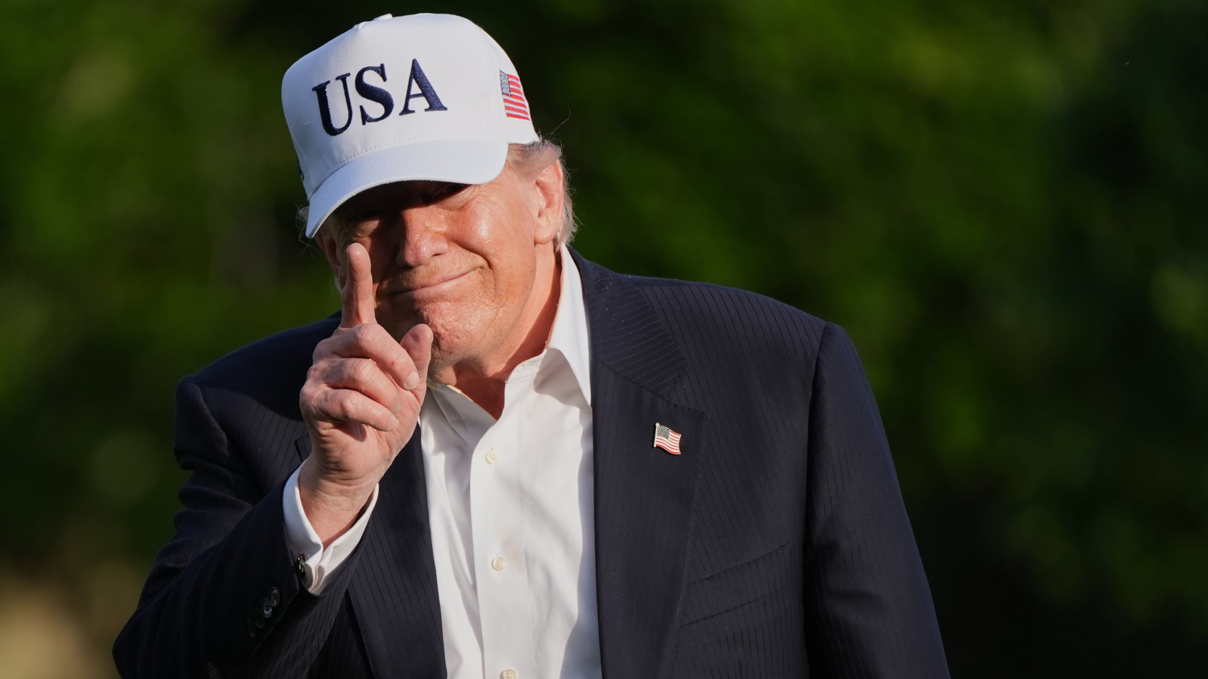 President Donald Trump gestures to reporters as he walks across the South Lawn of the White House, Friday, May 15, 2026, in Washington, on return from Beijing where he met with China's President Xi Jinping. (AP Photo/Jacquelyn Martin)