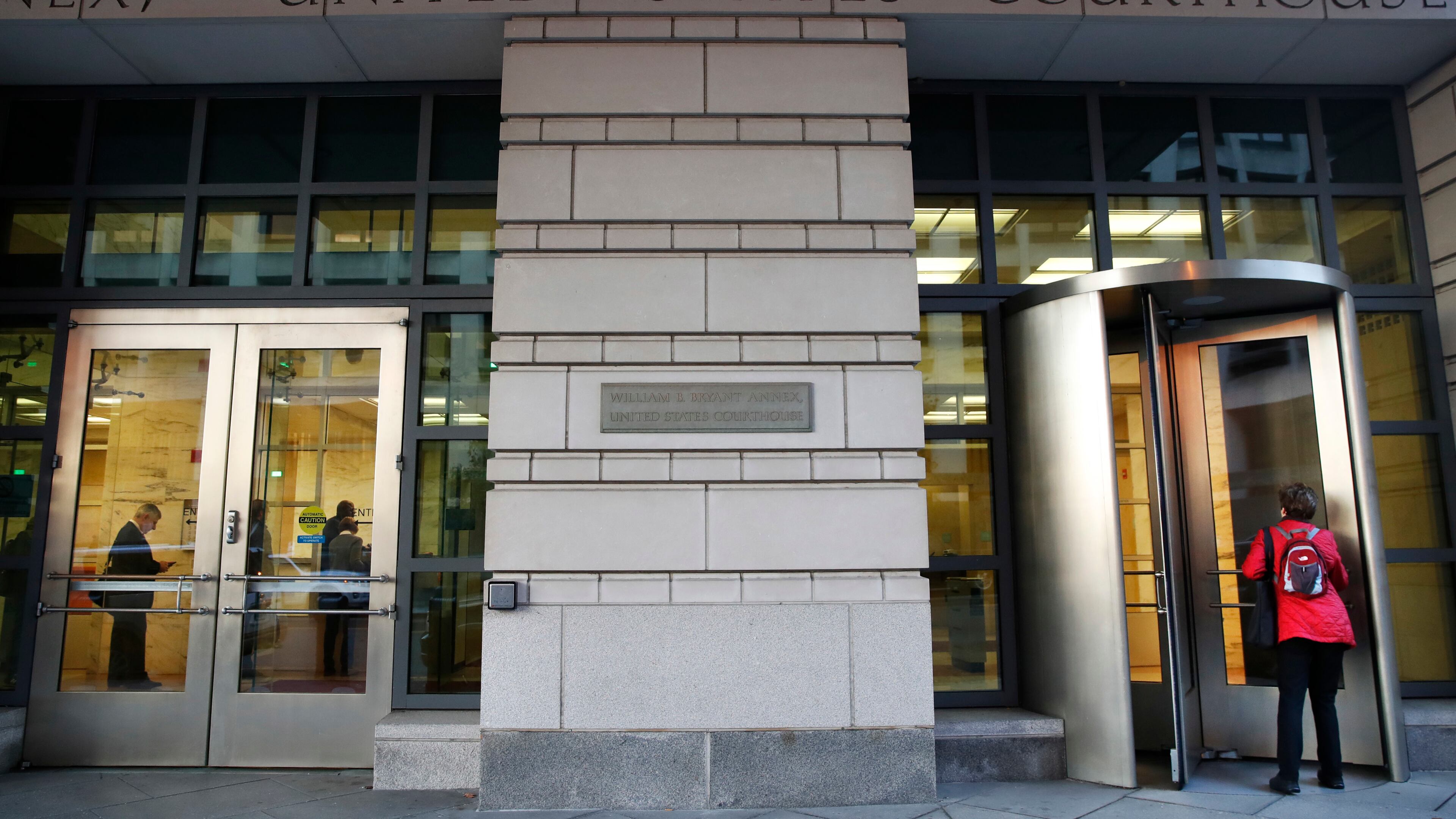 People enter the Federal Court on Monday in Washington. President Donald Trump's former campaign chairman, Paul Manafort, and a former business associate, Rick Gates, have been told to surrender to federal authorities. AP/Jacquelyn Martin