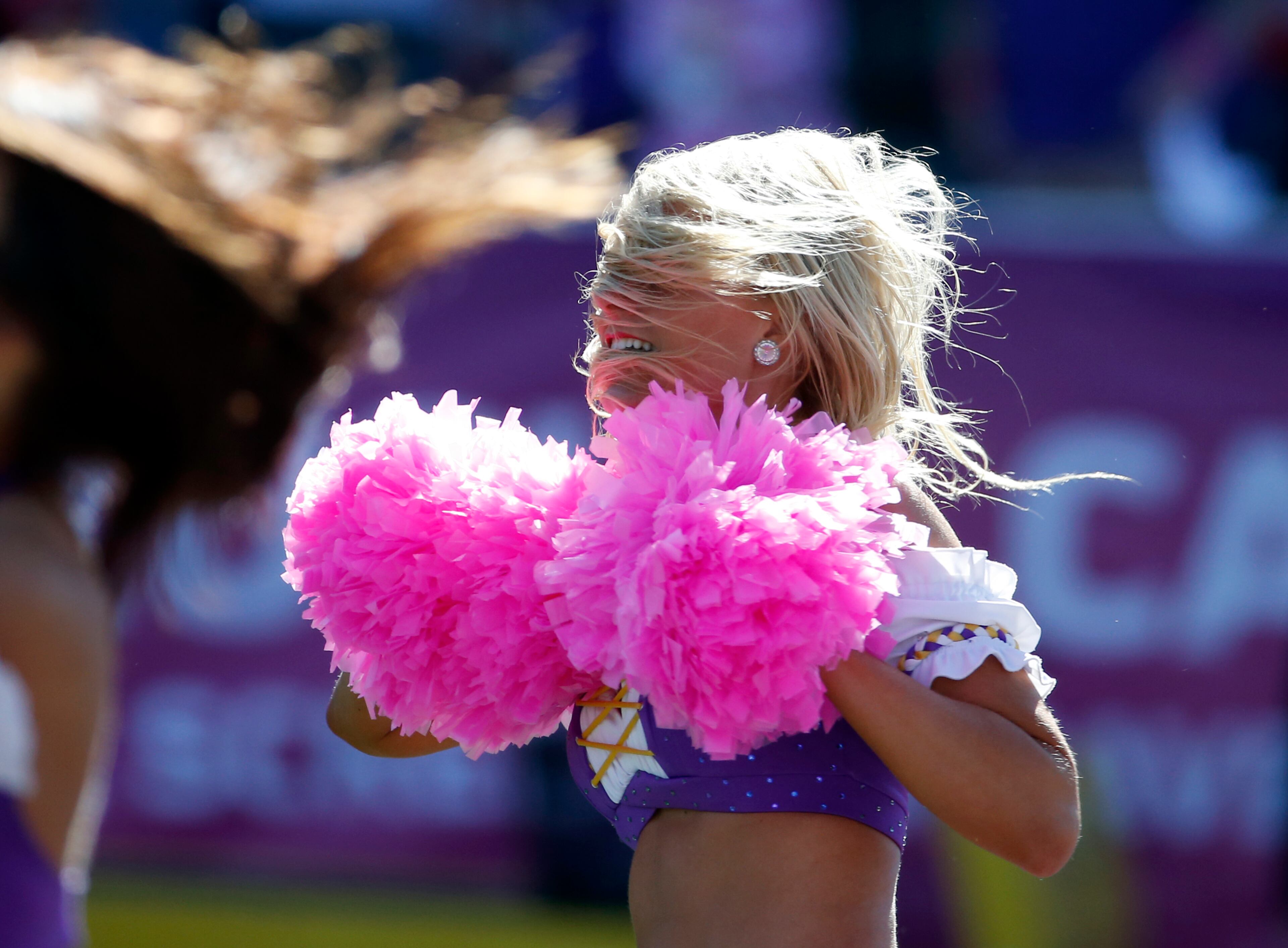 A Minnesota Vikings cheerleader performs with pink pom-poms for breast cancer awareness during the first half of an NFL football game against the Kansas City Chiefs, Sunday, Oct. 18, 2015, in Minneapolis. (AP Photo/Ann Heisenfelt)