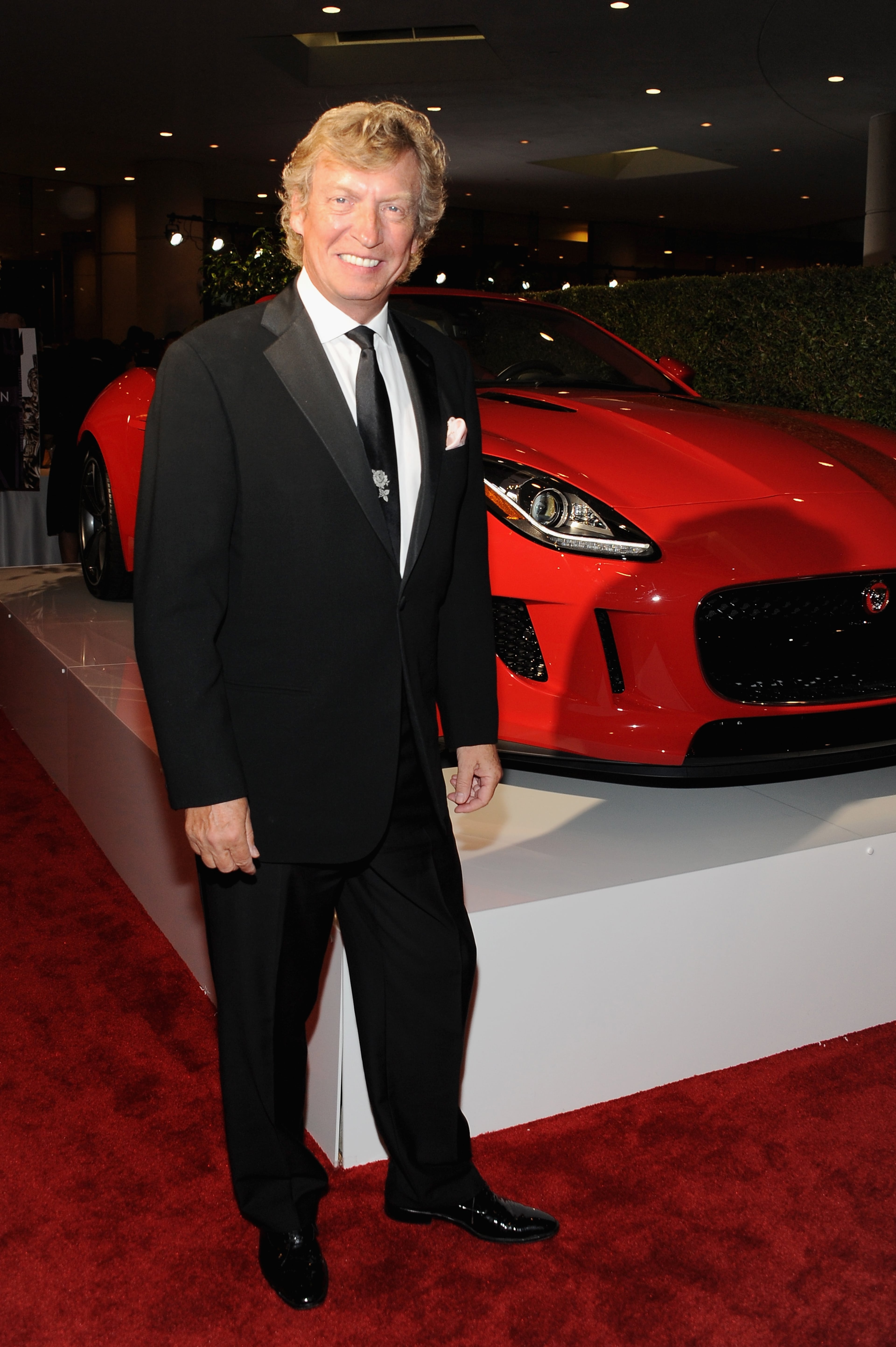 BEVERLY HILLS, CA - OCTOBER 30: Producer Nigel Lythgoe with the Jaguar F-TYPE Convertible at the 2014 BAFTA LA Jaguar Britannia Awards with Jaguar North America at The Beverly Hilton Hotel on October 30, 2014 in Beverly Hills, California. (Photo by Angela Weiss/Getty Images for Jaguar Land Rover)