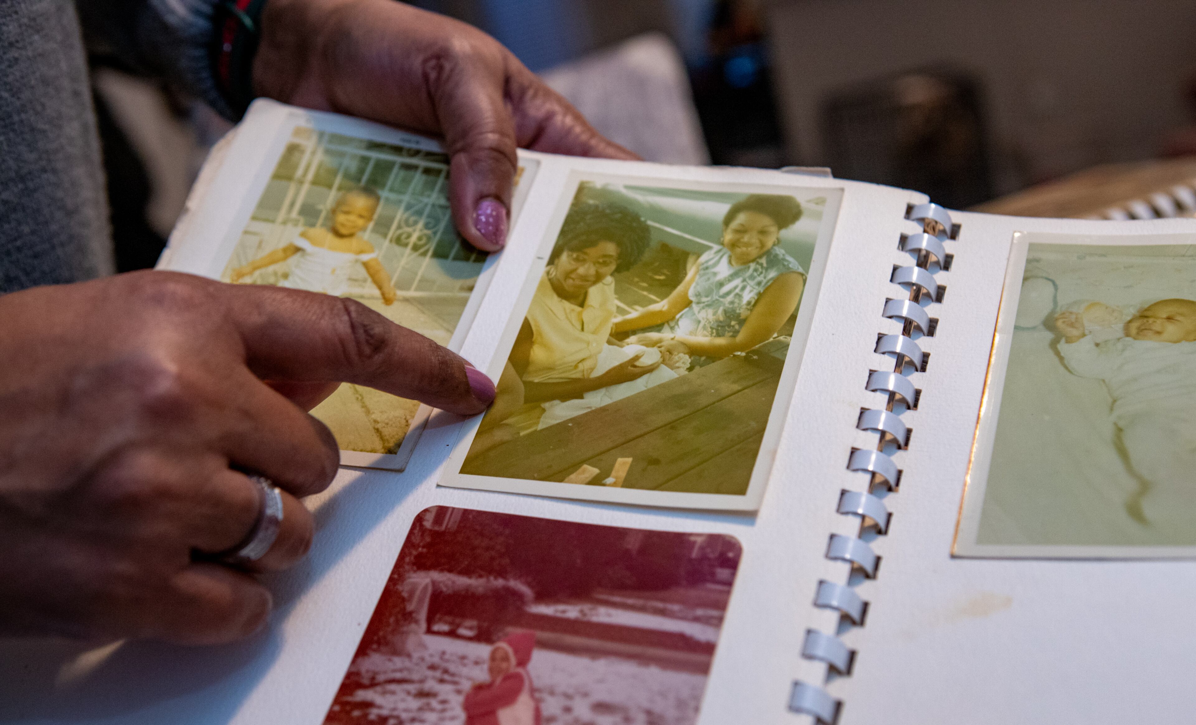 Linda Becquer-Pritchett shares a family photo of Latin music legend Celia Cruz holding her as an infant on Friday, Jan 26, 2024 at her home. The South Fulton councilwoman grew up with in Brooklyn sharing a home with Cruz and was often cared for by her aunt while her mother was busy with Linda's twin siblings. (Jenni Girtman for The Atlanta Journal-Constitution)