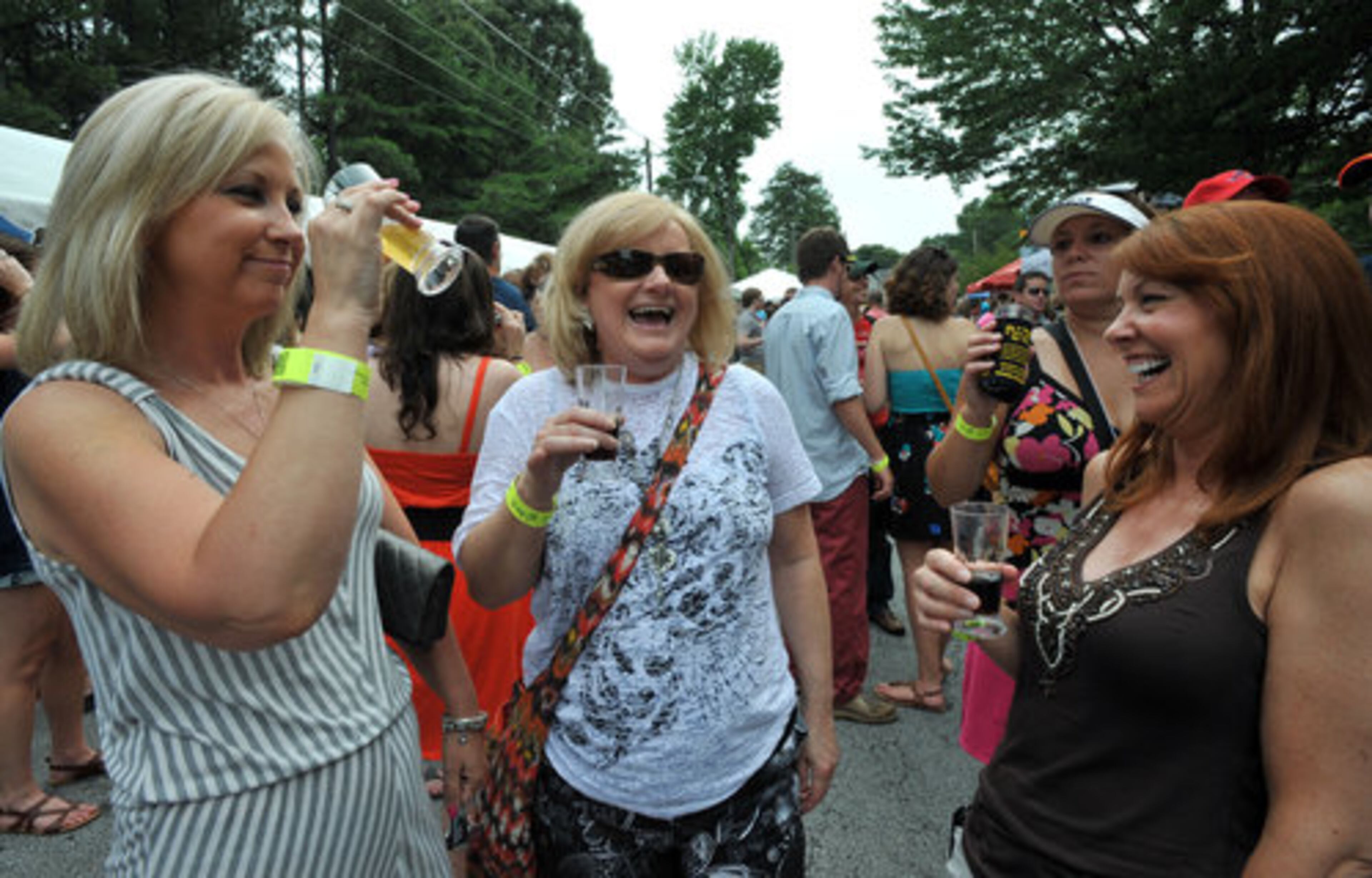 Lori Cowie (from left), Sonya Morris and Bridget Cody, all of Atlanta, take a break from sampling beers to share a laugh.