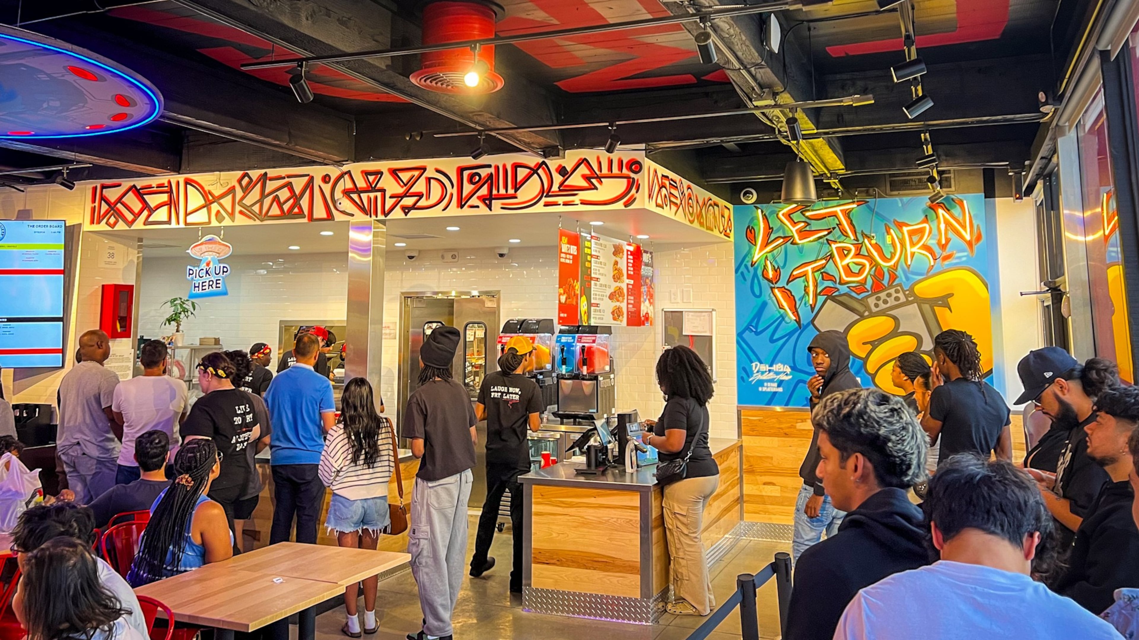 The Atlanta-themed dining room at Dave's Hot Chicken in Conyers was packed early on a Sunday evening. (Henri Hollis/henri.hollis@ajc.com)