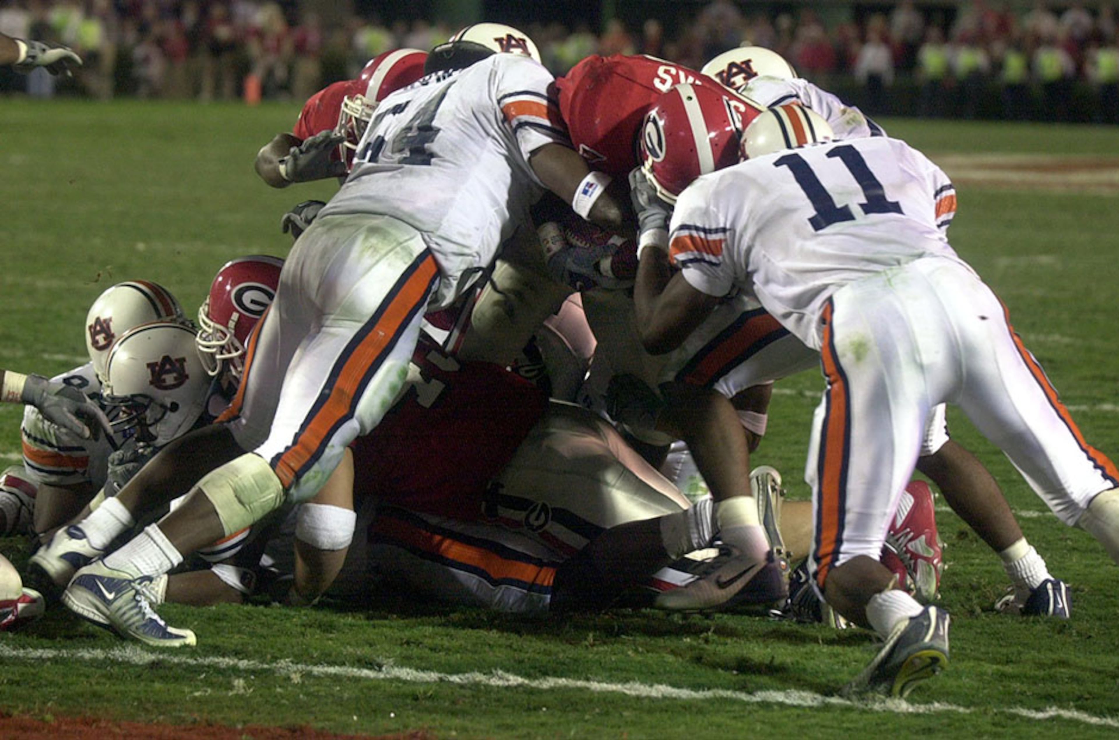 Georgia's Jasper Sanks is stopped short of the goal line by Auburn's Dontarrious Thomas (left) and Karlos Dansby on the last play of the game - a 24-17 loss - on Nov. 10, 2001, in Athens, Ga.