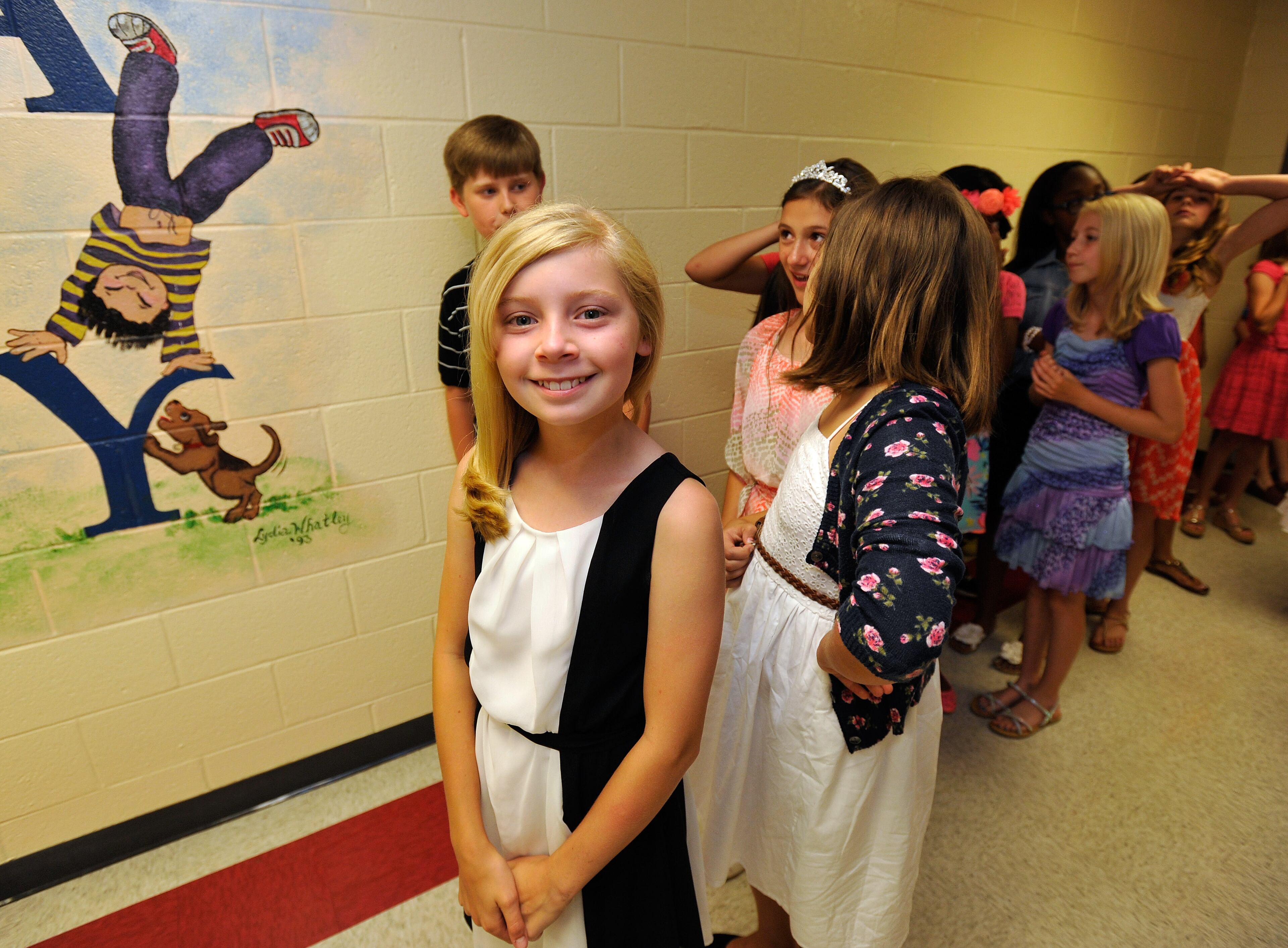 Alpharetta Elementary School fifth grader Lauren Mackenzi participates in a school tradition walking the hallways one last time to celebrate graduation Friday, May 23, 2014, in Alpharetta, Ga. David Tulis / AJC Special