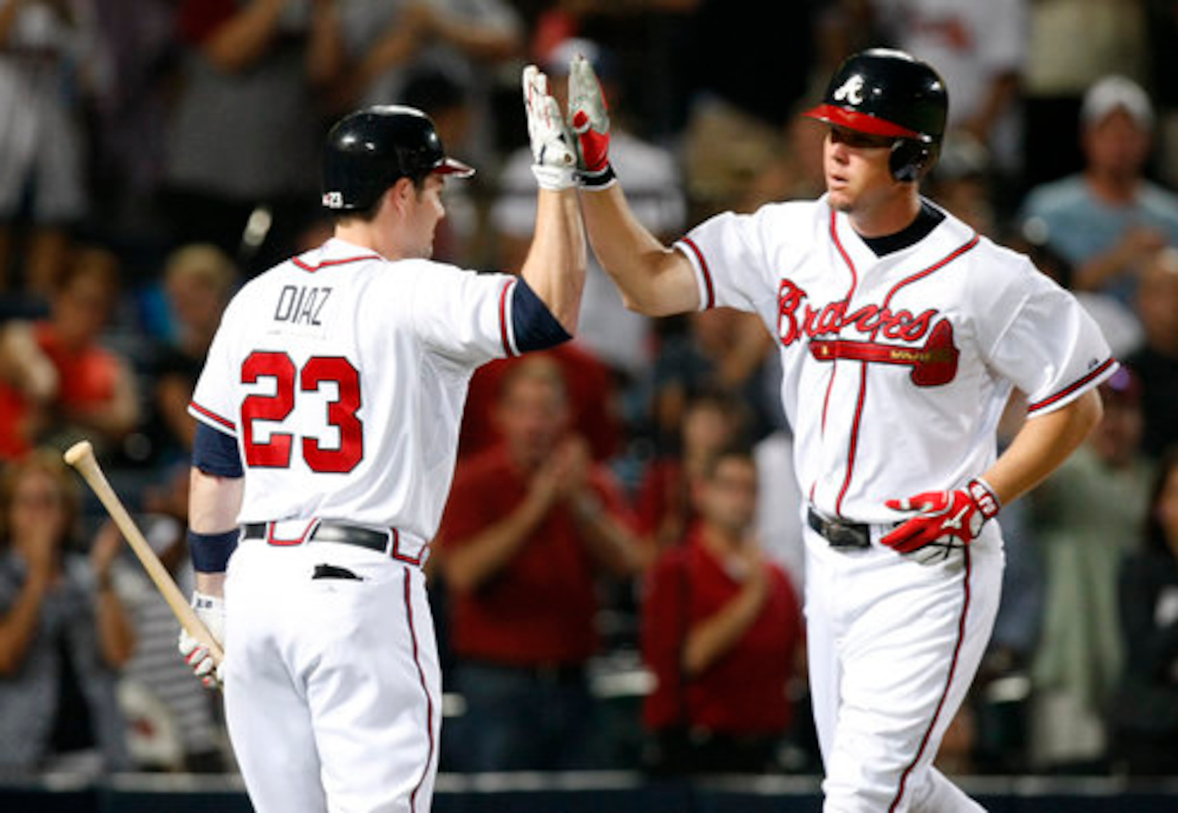 tlanta Braves Chipper Jones is greeted at home by Matt Diaz after hitting a solo home run to give the Braves a 2-1 lead over the San Francisco Giants during 6th inning action at Turner Field in Atlanta, Friday, August 6, 2010.