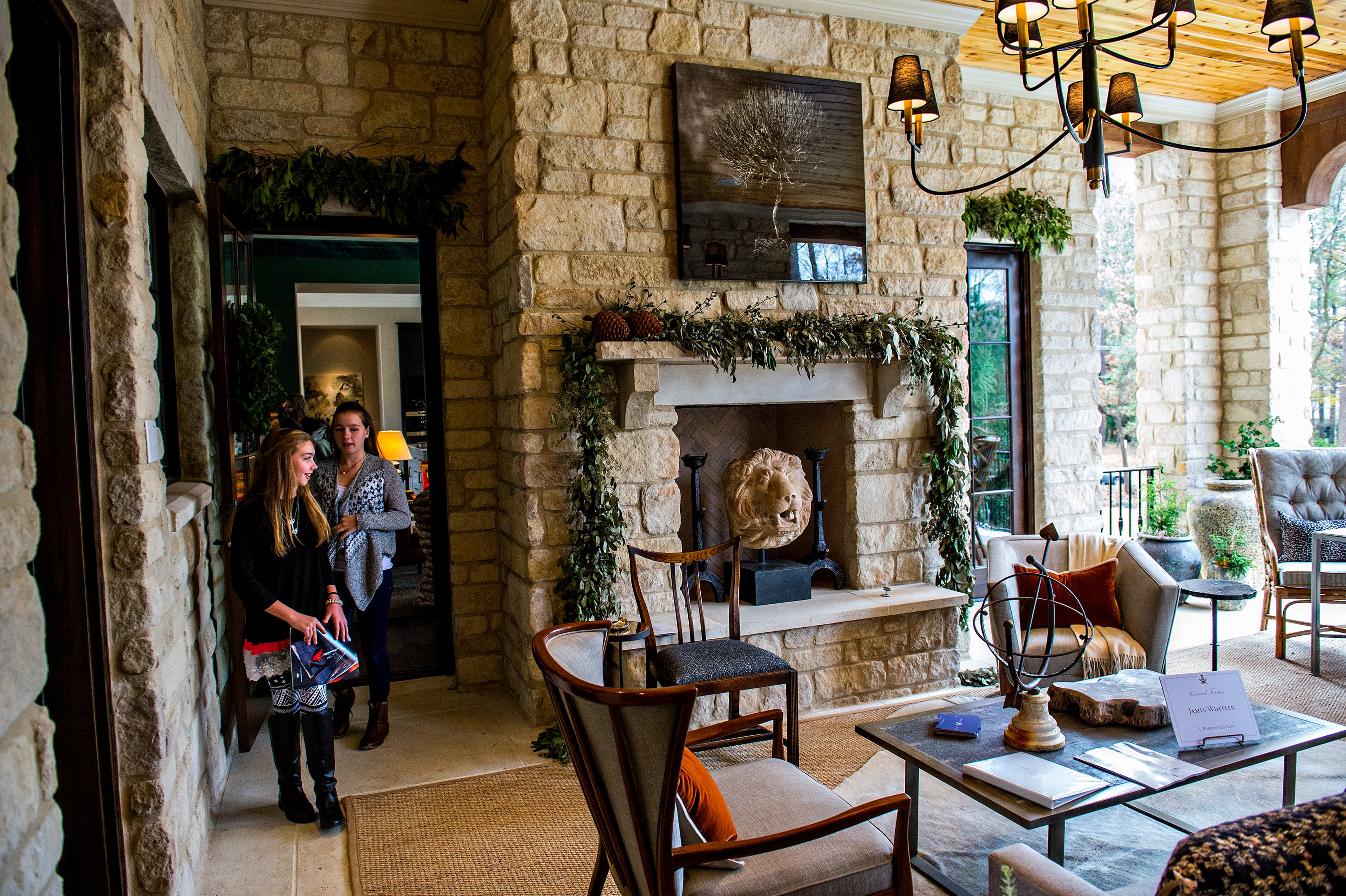 November 21, 2015 Atlanta - Zoie Bell (left) and Kaitlyn Oleson check out the outdoor patio at the 2015 Home for the Holidays Designer Showhouse located at 1150 West Garmon Rd. in Atlanta on Saturday, November 21, 2015. This year's 15,000 sq. ft. estate is a collaboration between renowned architecture firm, Harrison Design, and Sheehan Built Homes. Inspired by Scotland's Stonefield Castle, the sprawling "Millwood Manor" is open through Sunday, Dec. 13. JONATHAN PHILLIPS / SPECIAL