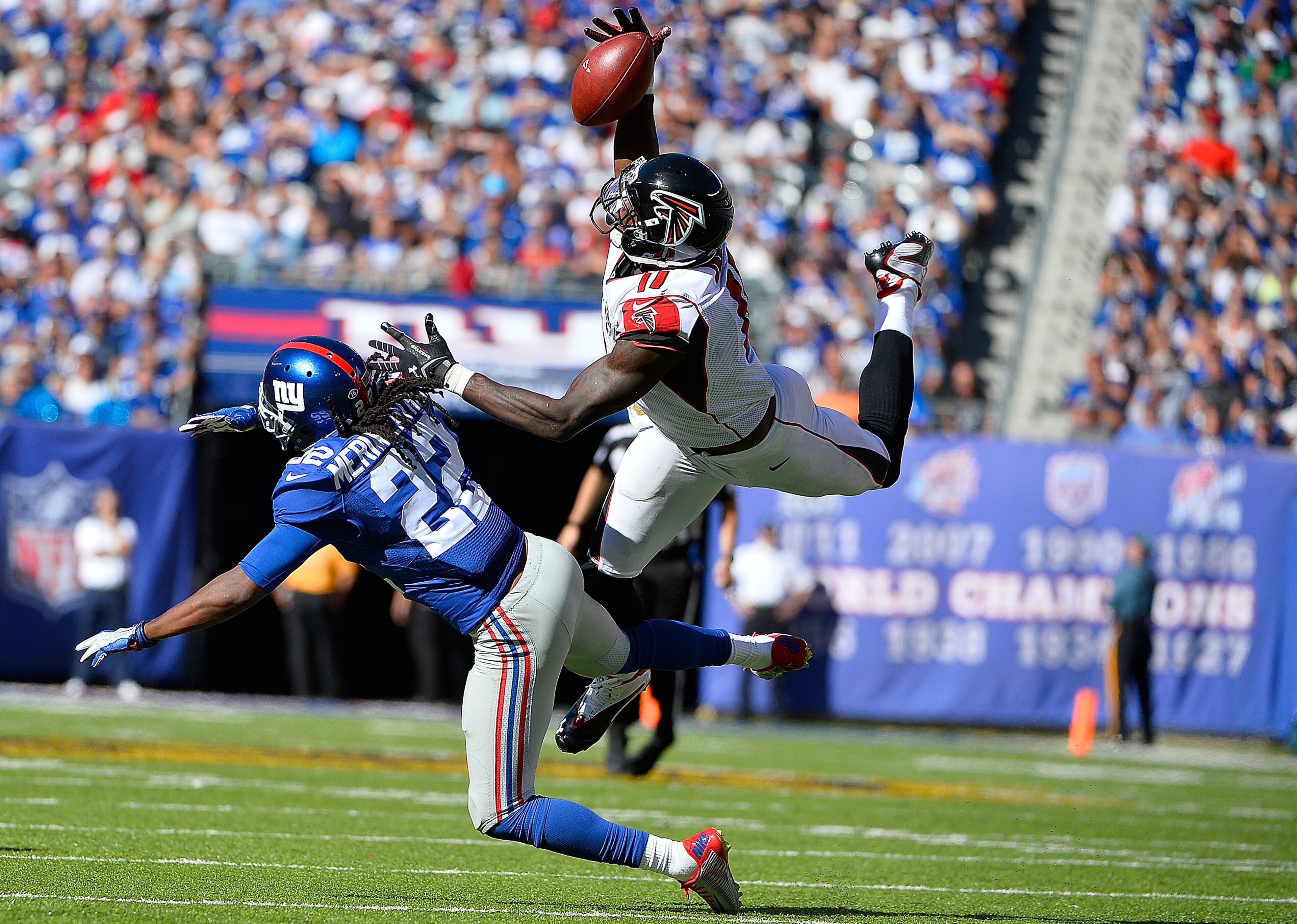 EAST RUTHERFORD, NJ - SEPTEMBER 20: Julio Jones #11 of the Atlanta Falcons makes a first down reception in the fourth quarter under pressure from Brandon Meriweather #22 of the New York Giants at MetLife Stadium on September 20, 2015 in East Rutherford, New Jersey. The Atlanta Falcons defeated the New York Giants 24-20. (Photo by Alex Goodlett/Getty Images)