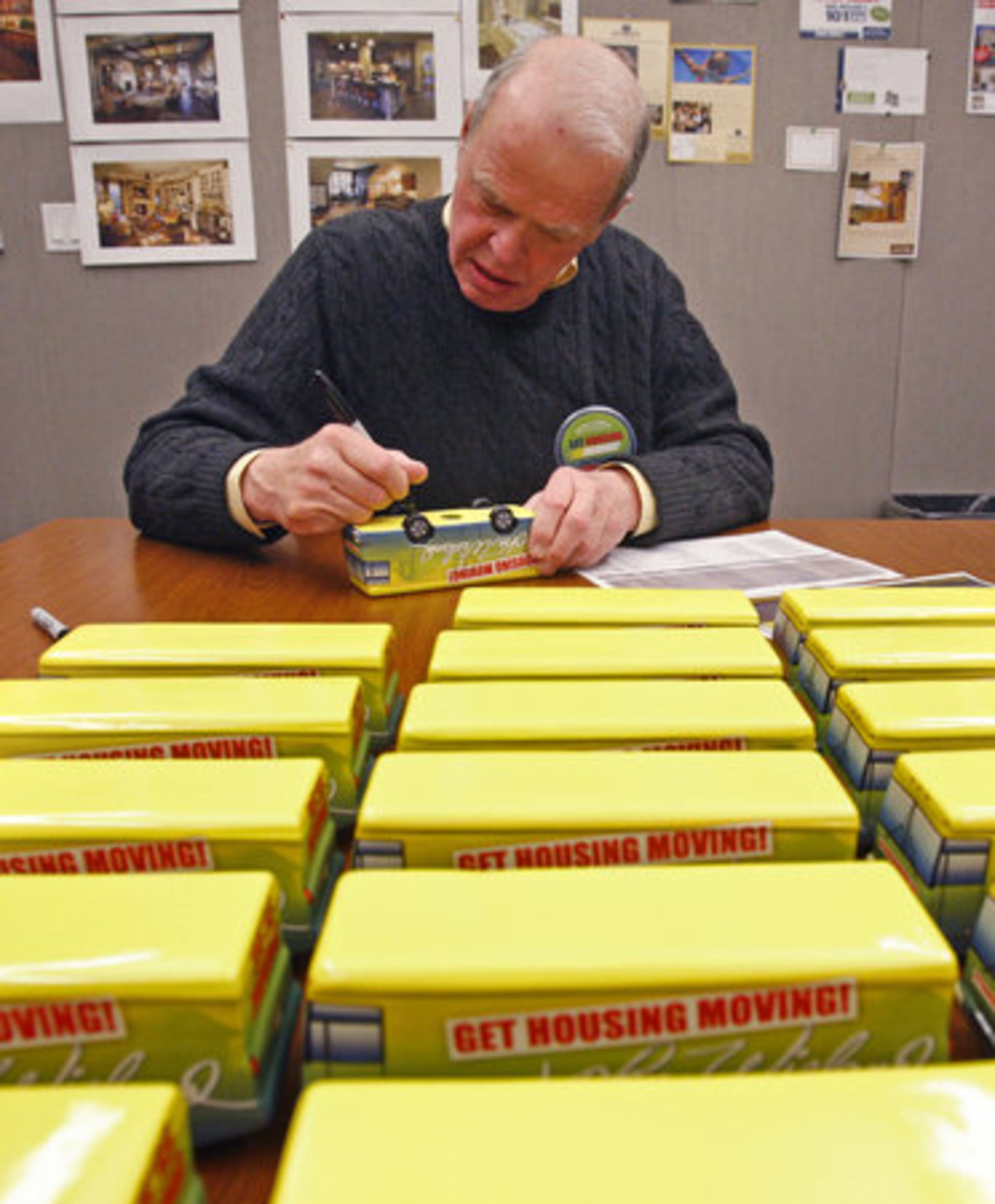 Wieland signs ceramic "Wiebagos" at his headquarters in Smyrna. Each buyer of one of the 101 houses gets one of the numbered and autographed models.