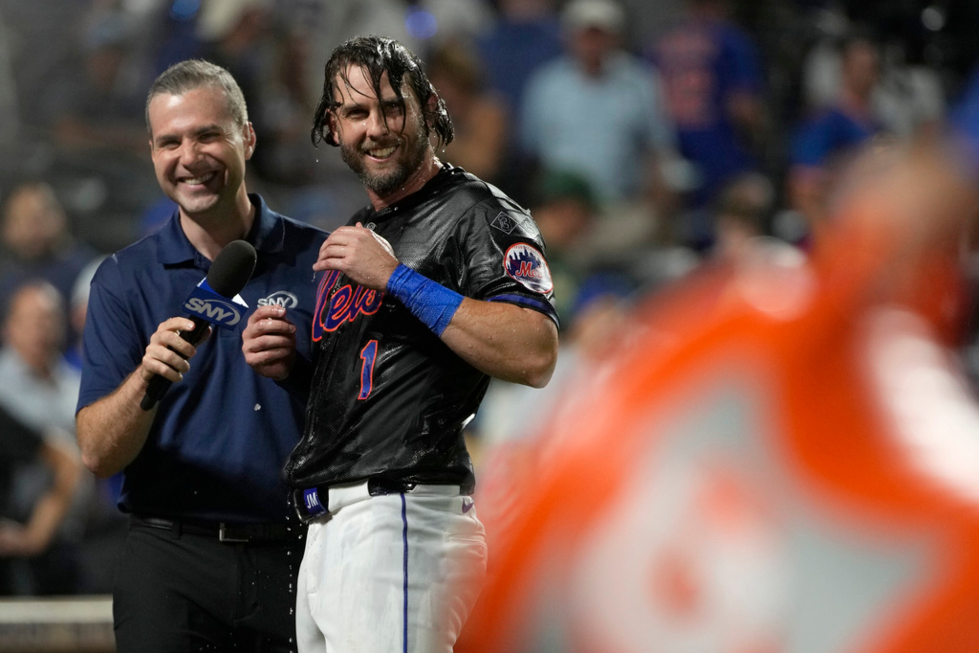 New York Mets' Jeff McNeil, right, reacts after being doused by DJ Stewart (not shown) after the 10th inning of a baseball game against the Atlanta Braves, Thursday, July 25, 2024, in New York. (AP Photo/Pamela Smith)