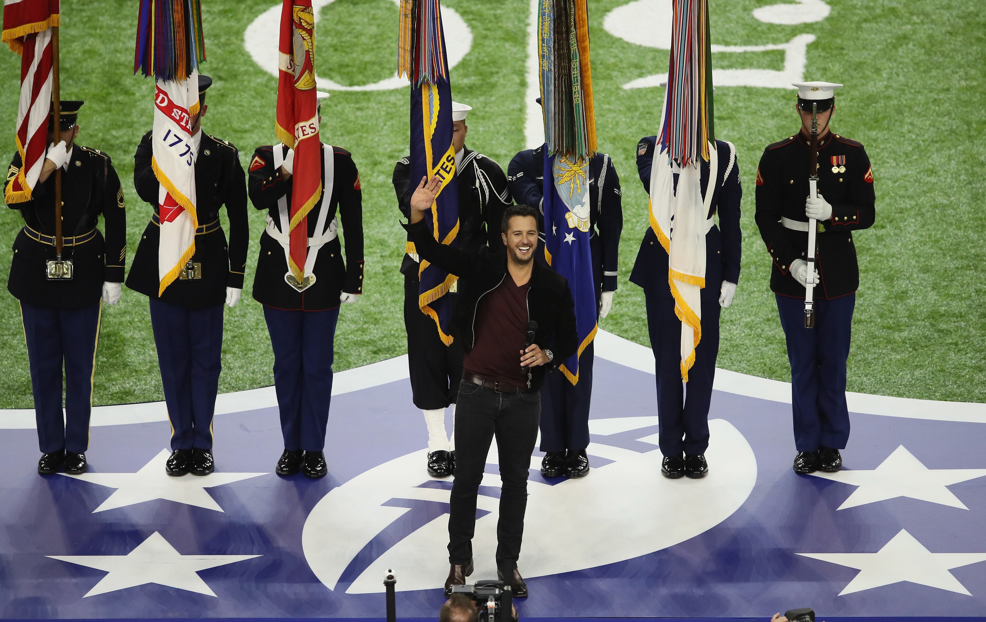 HOUSTON, TX - FEBRUARY 05: Luke Bryan sings the National Anthem prior to Super Bowl 51 between the New England Patriots and the Atlanta Falcons at NRG Stadium on February 5, 2017 in Houston, Texas. (Photo by Elsa/Getty Images)