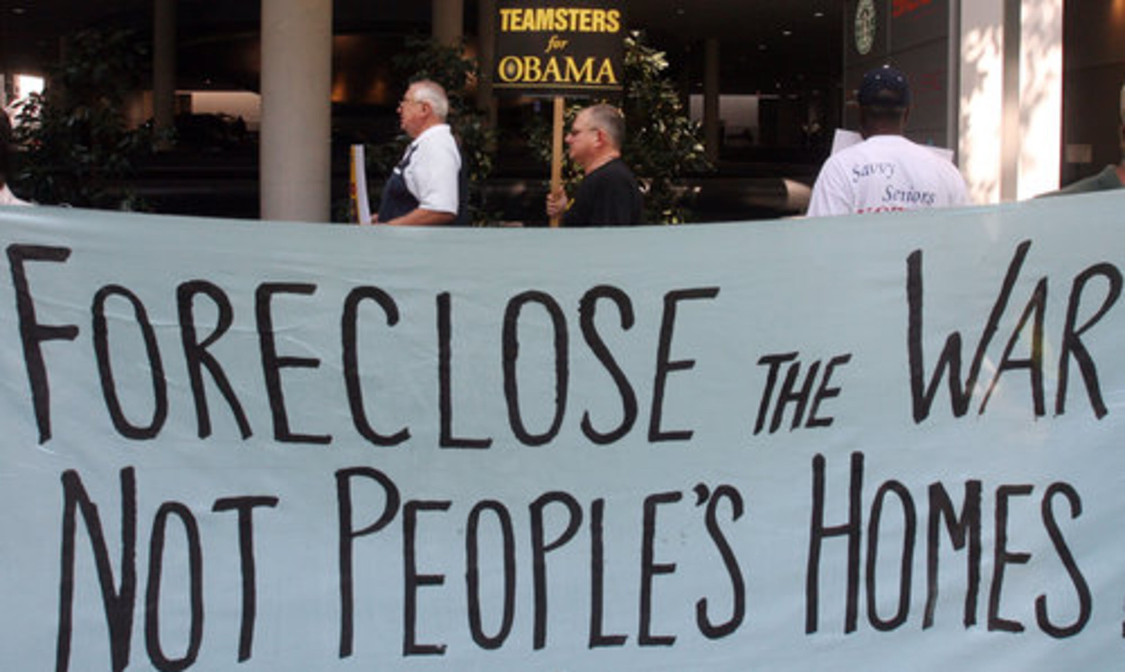 Ralph Meers (left) of the Graphic Communication Union, and other protesters gather in front of the Marriott Marquis in Atlanta. The protesters arrived two hours prior to John McCain's scheduled fund-raiser at the hotel with the Republican National Committee.