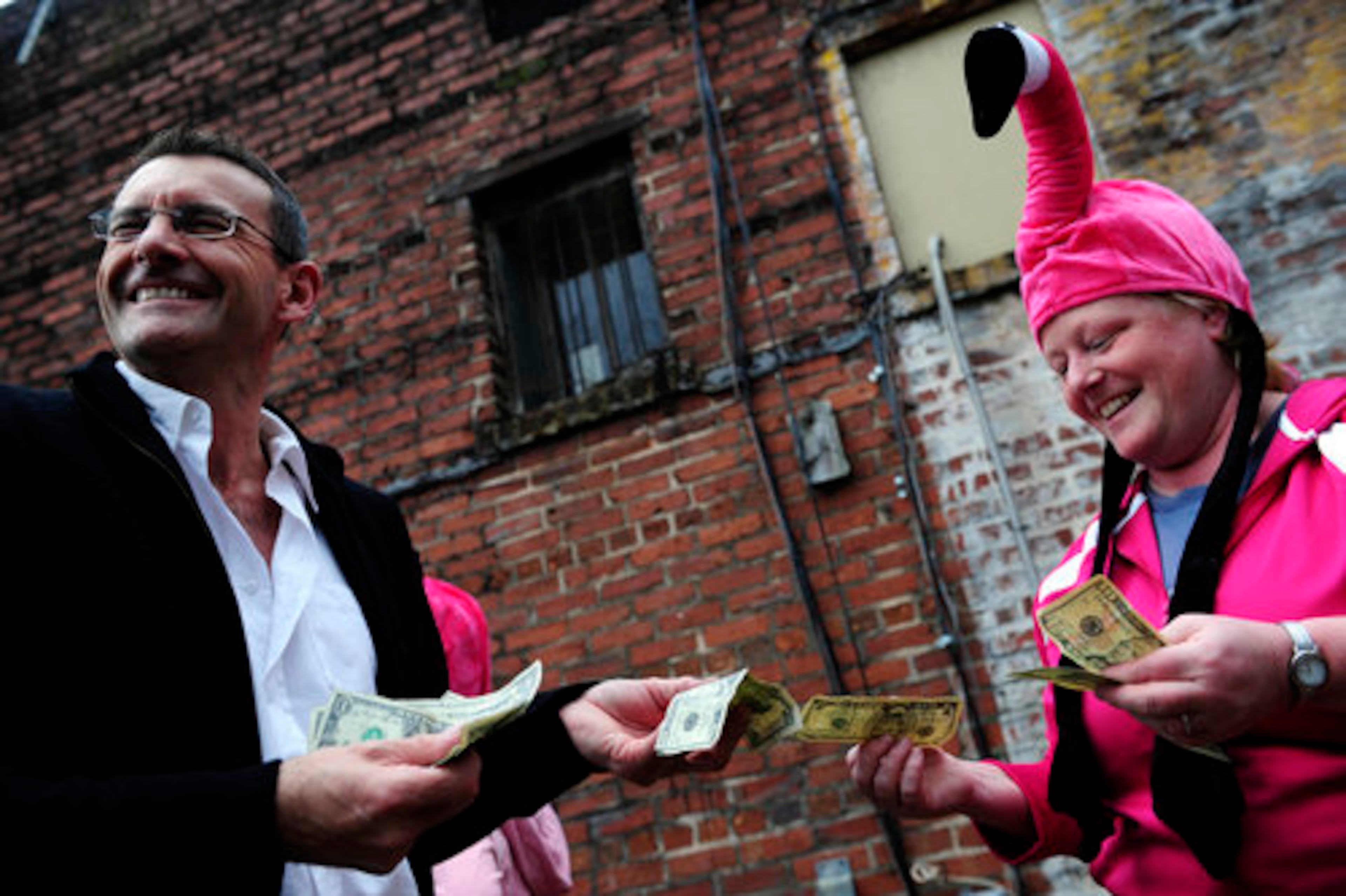 East Atlanta residents, Stephen Fitzpatrick, 45, buys two pink flamingos for his yard from Helen Cabe, 40, behind Joe's Coffee in East Atlanta.